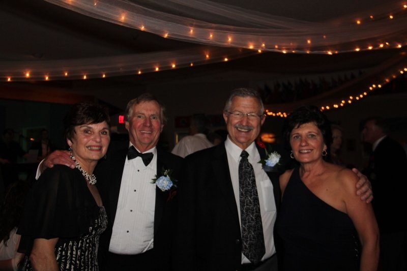 A group of people posing for a picture in a dark room.