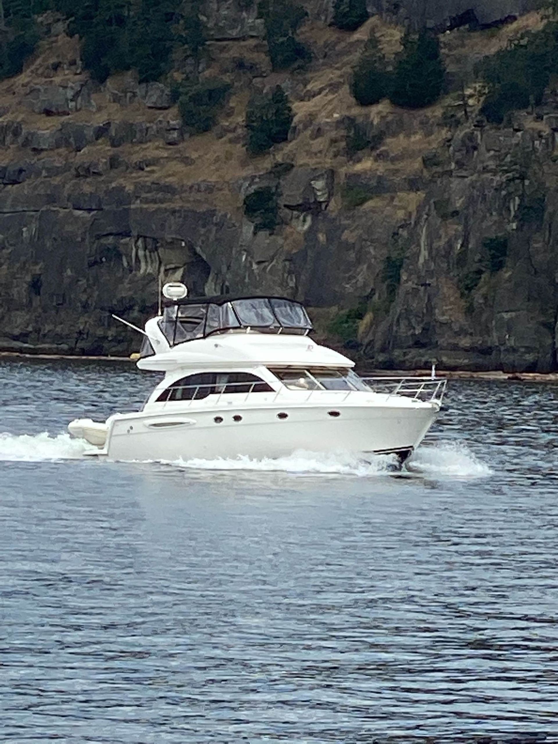 A white boat is floating on top of a body of water.