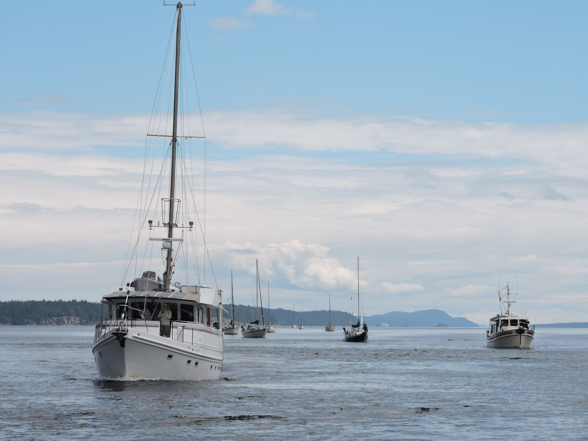 A group of boats are floating on top of a body of water.