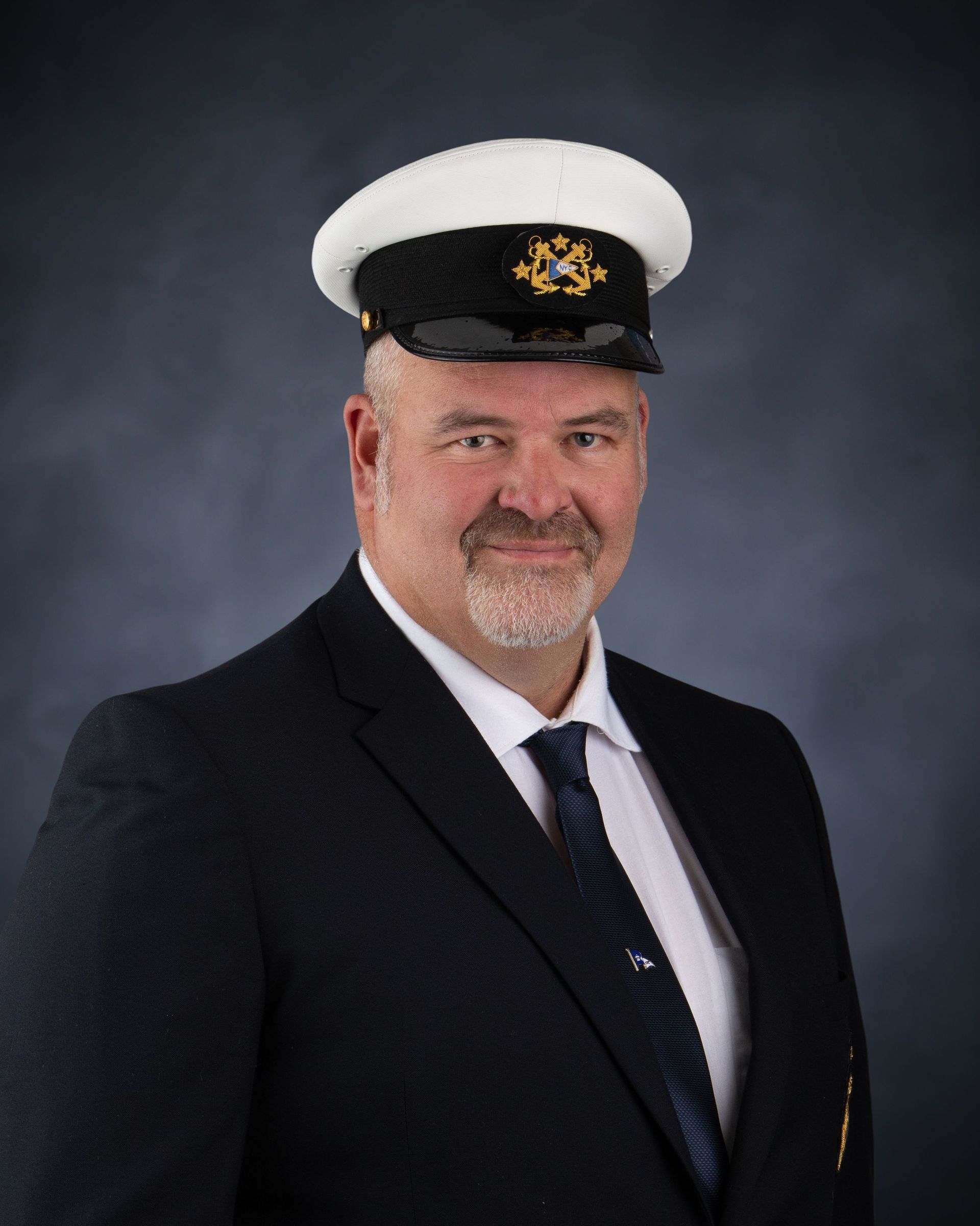 A man in a suit and tie is smiling for the camera.