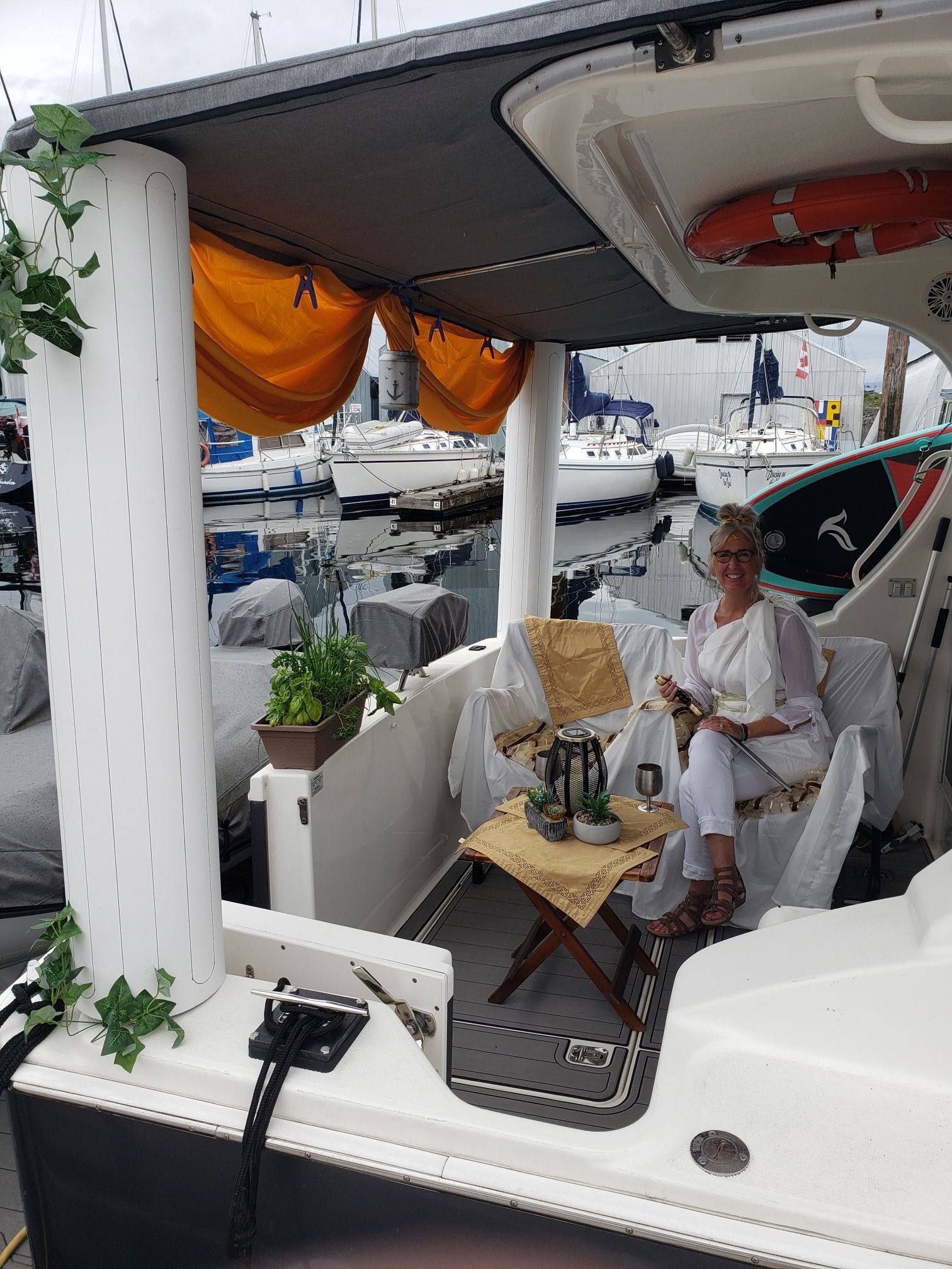 A woman is sitting on a boat holding a cup of coffee.