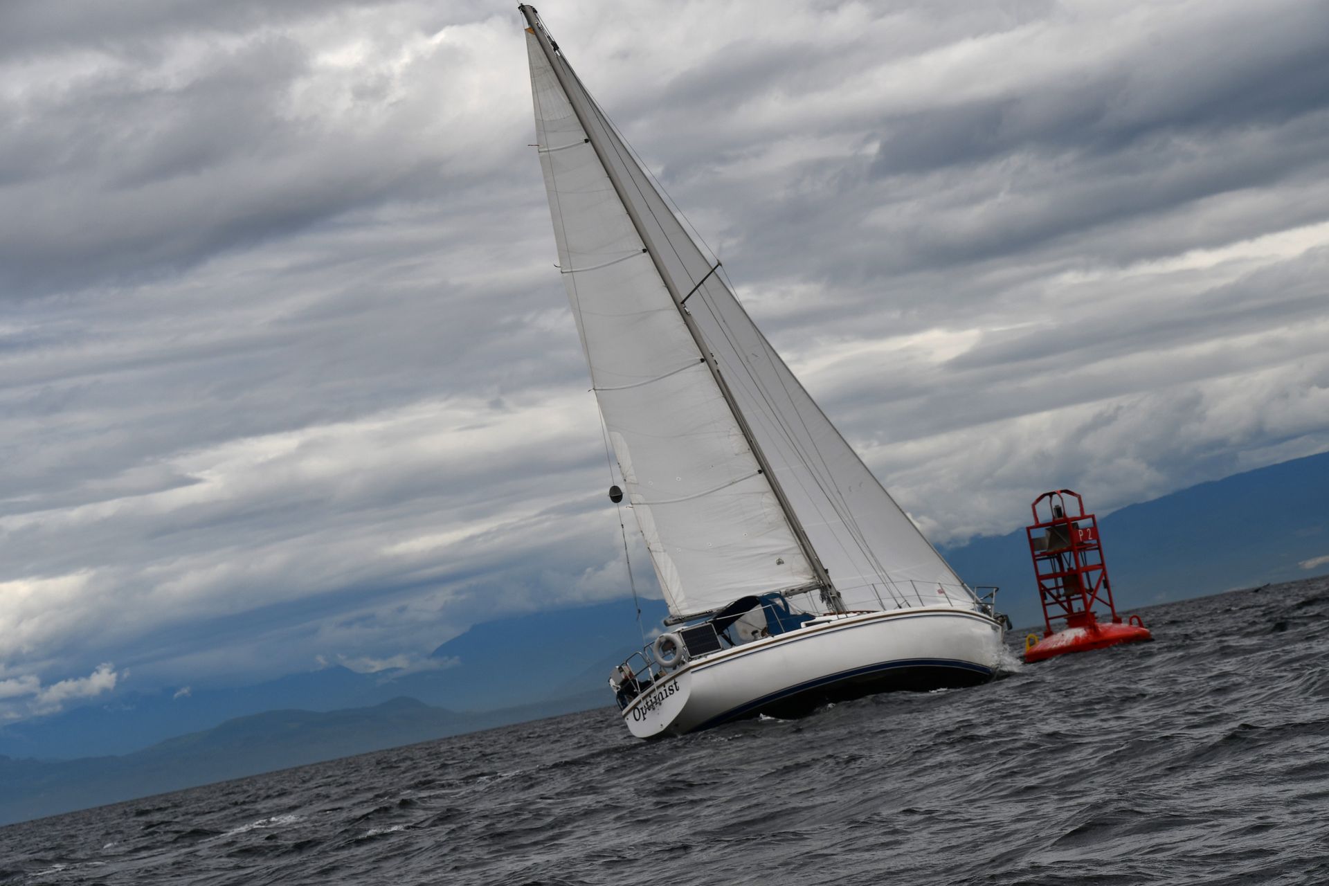 A sailboat is floating on top of a body of water.
