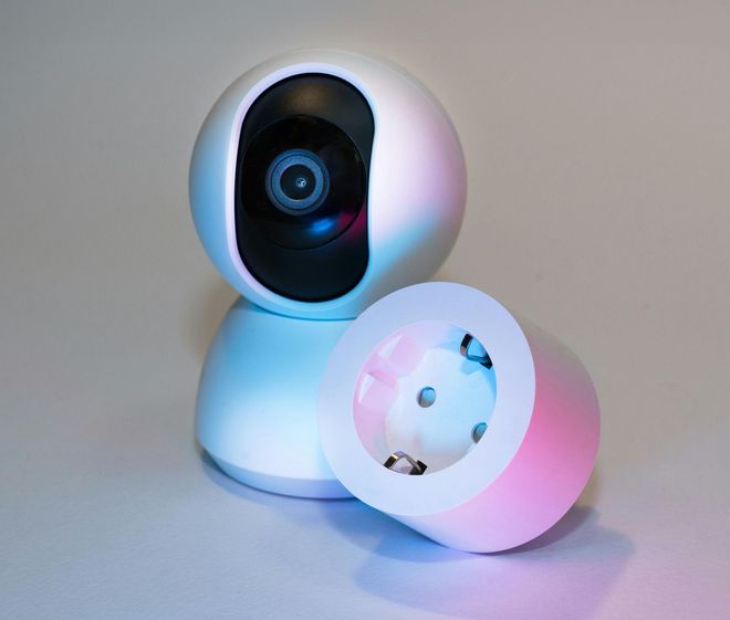 A camera is sitting on a table next to a socket.