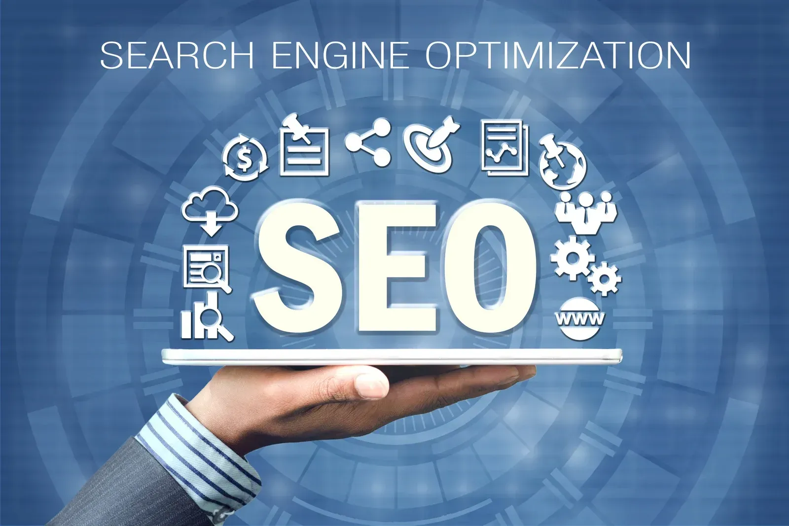 A hand is holding a tablet with the word seo on it.