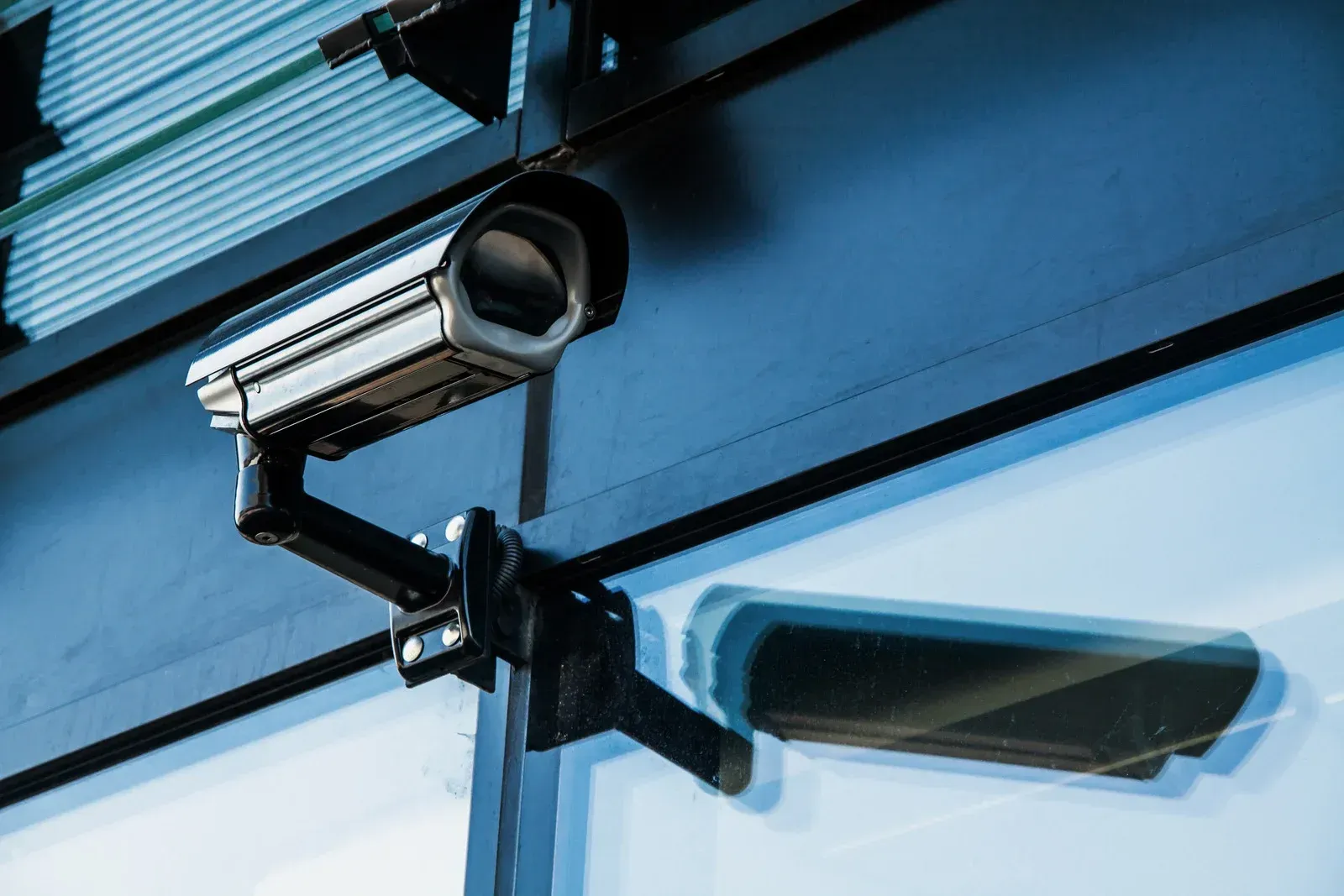 A security camera is mounted on the side of a building.