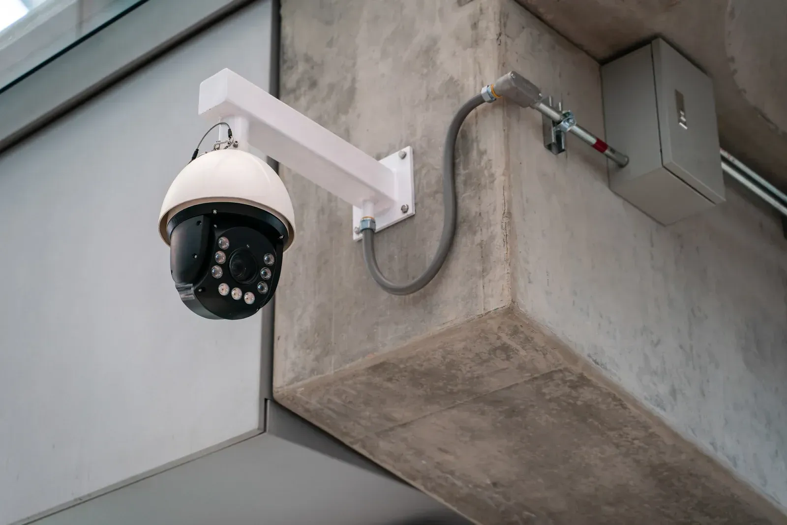A security camera is mounted on the side of a building.