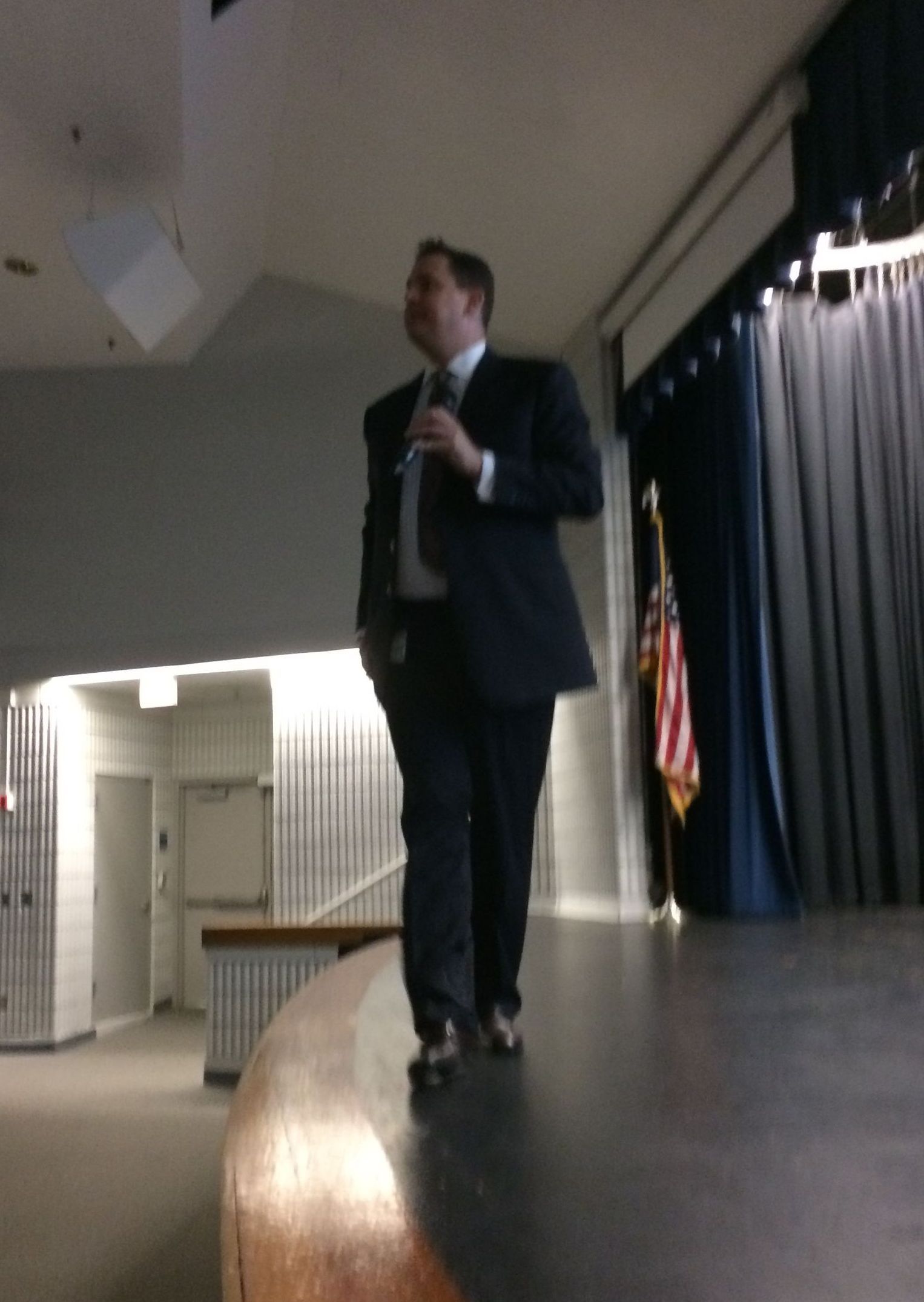 A man in a suit and tie is standing on a stage