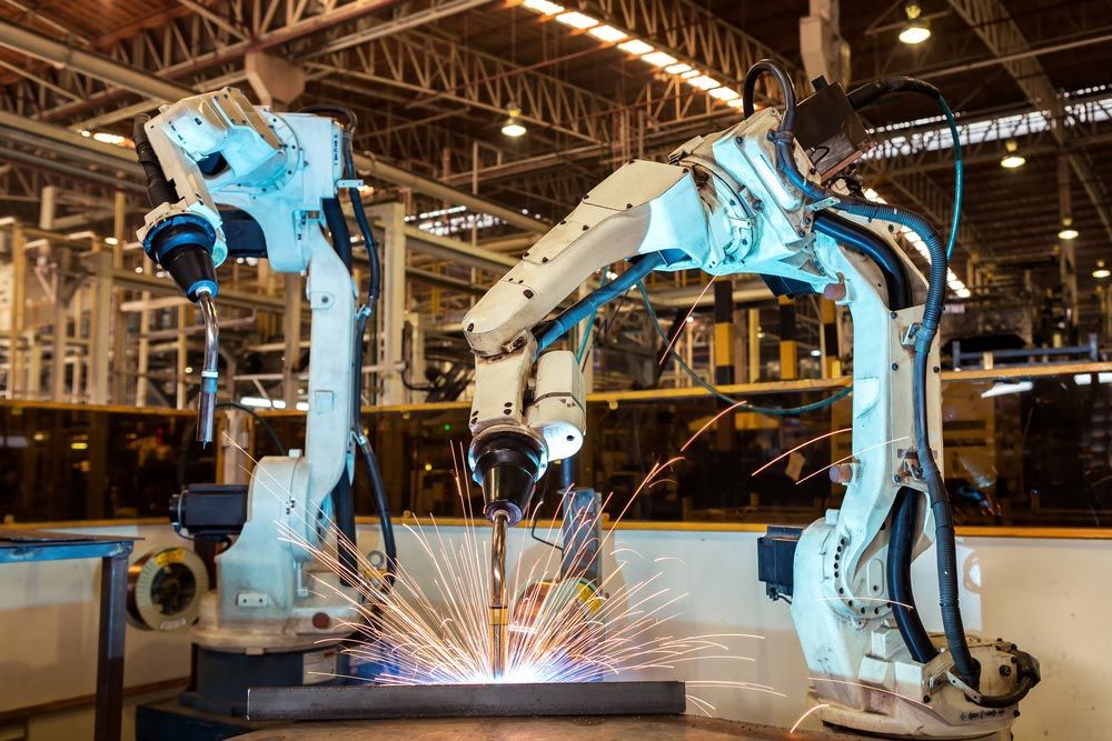 A Robotic Arm Is Welding A Piece Of Metal In A Factory - Welding Equipment & Services in Townsville