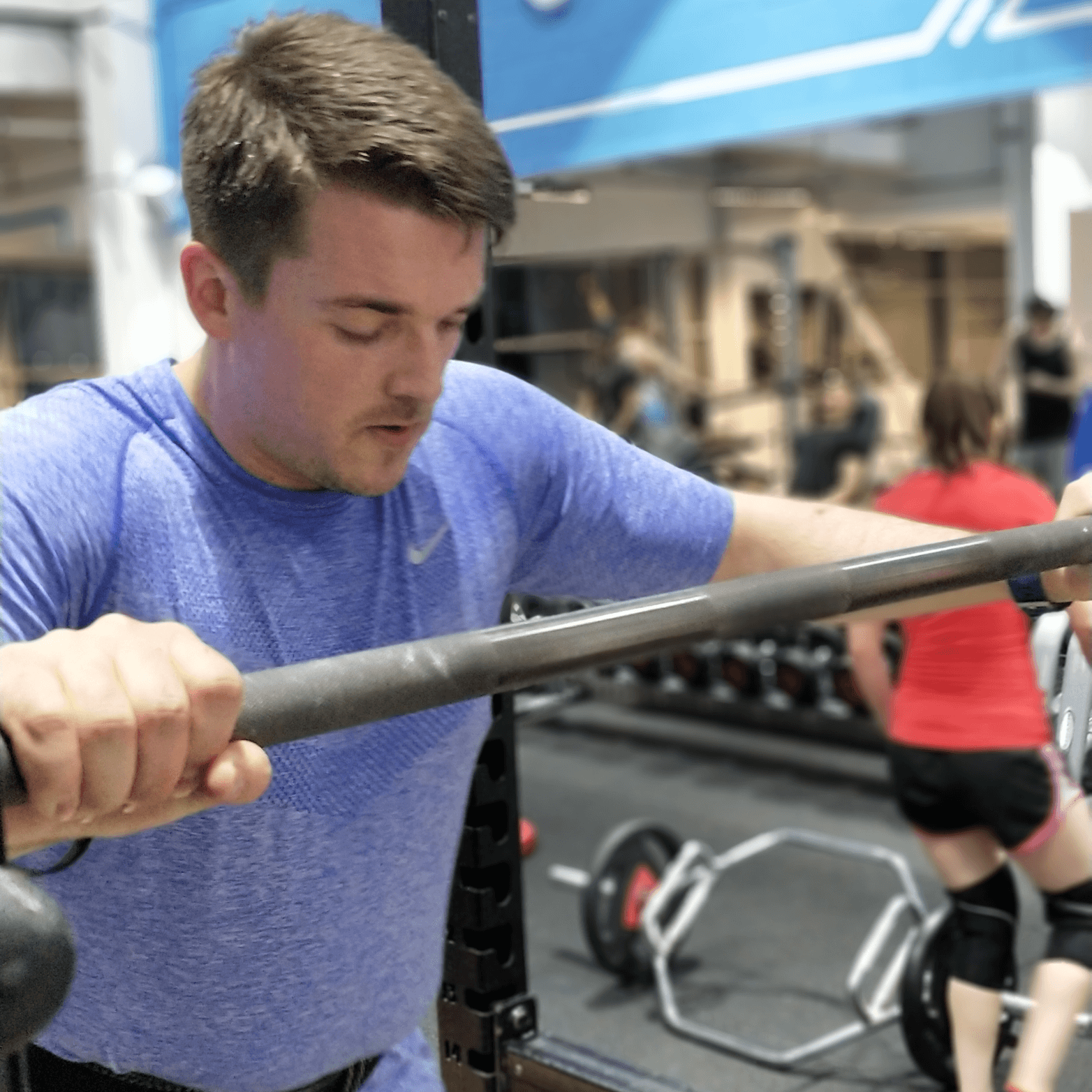 Client preparing to squat at personal training session in Glasgow