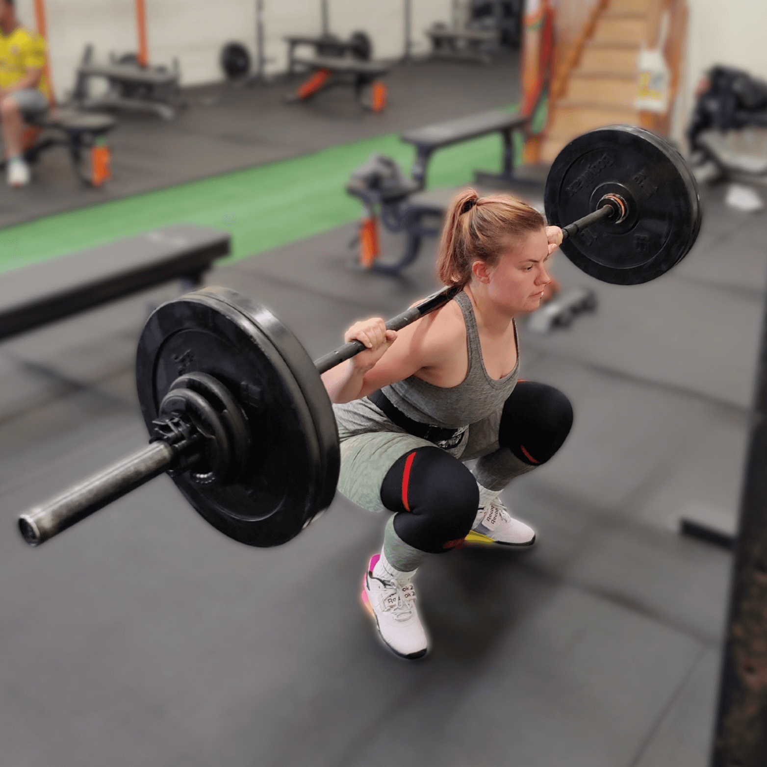 Client squatting during a Glasgow personal training session at Learn to Lift Training