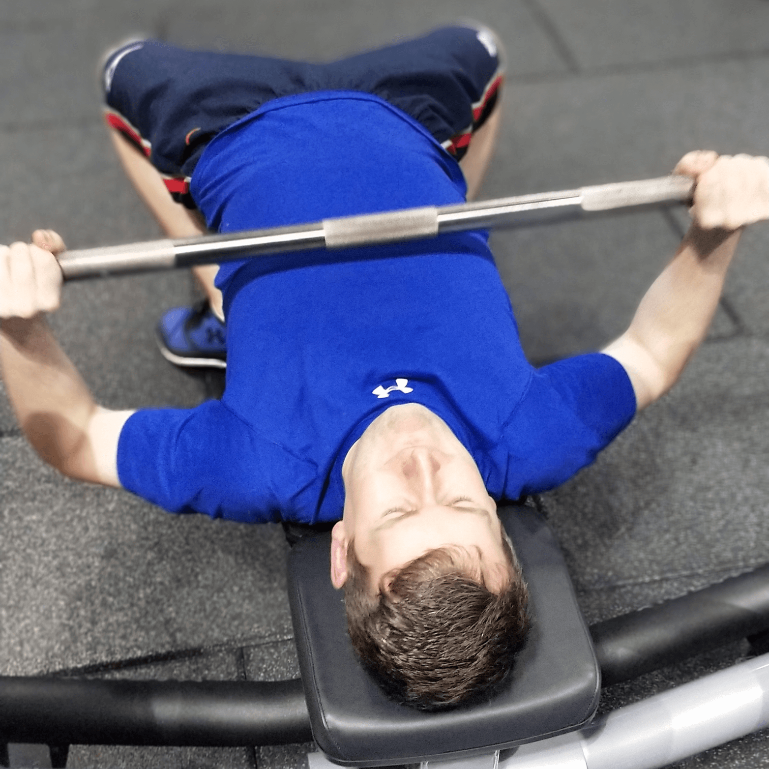 Man bench pressing with Glasgow personal trainer