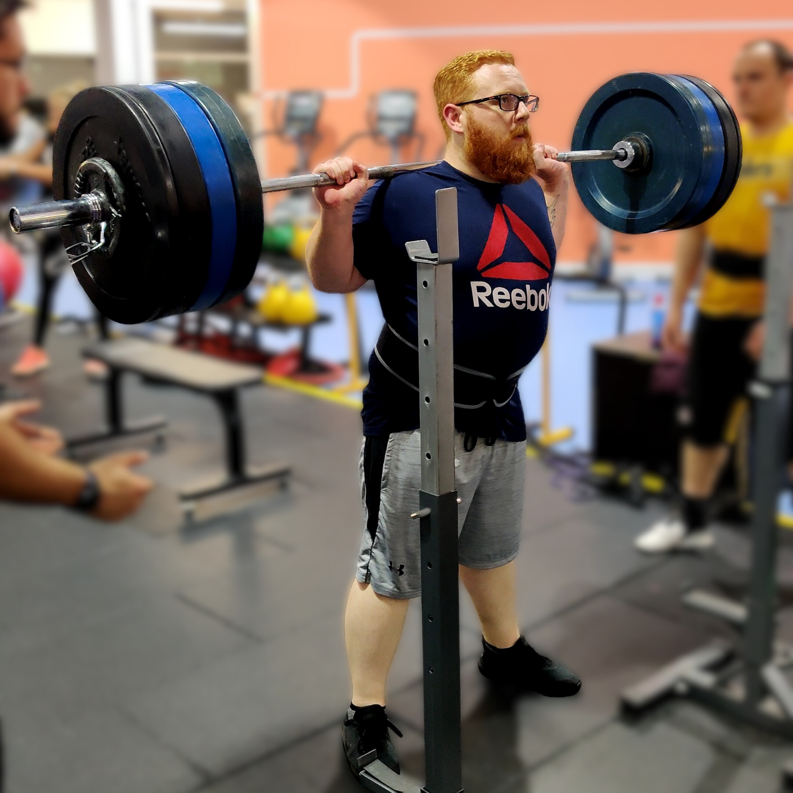 Man squatting at Learn to Lift Bootcamp Glasgow