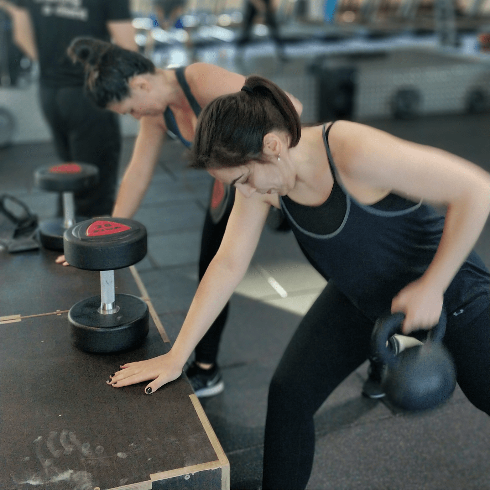 Two clients at Learn to Lift Bootcamp in Glasgow performing one arm rows