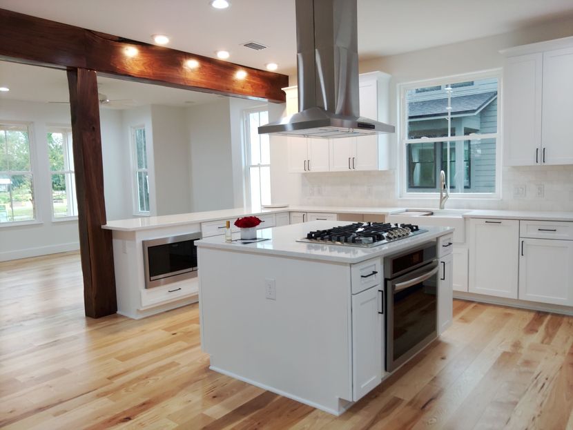 A kitchen with white cabinets and a large island.