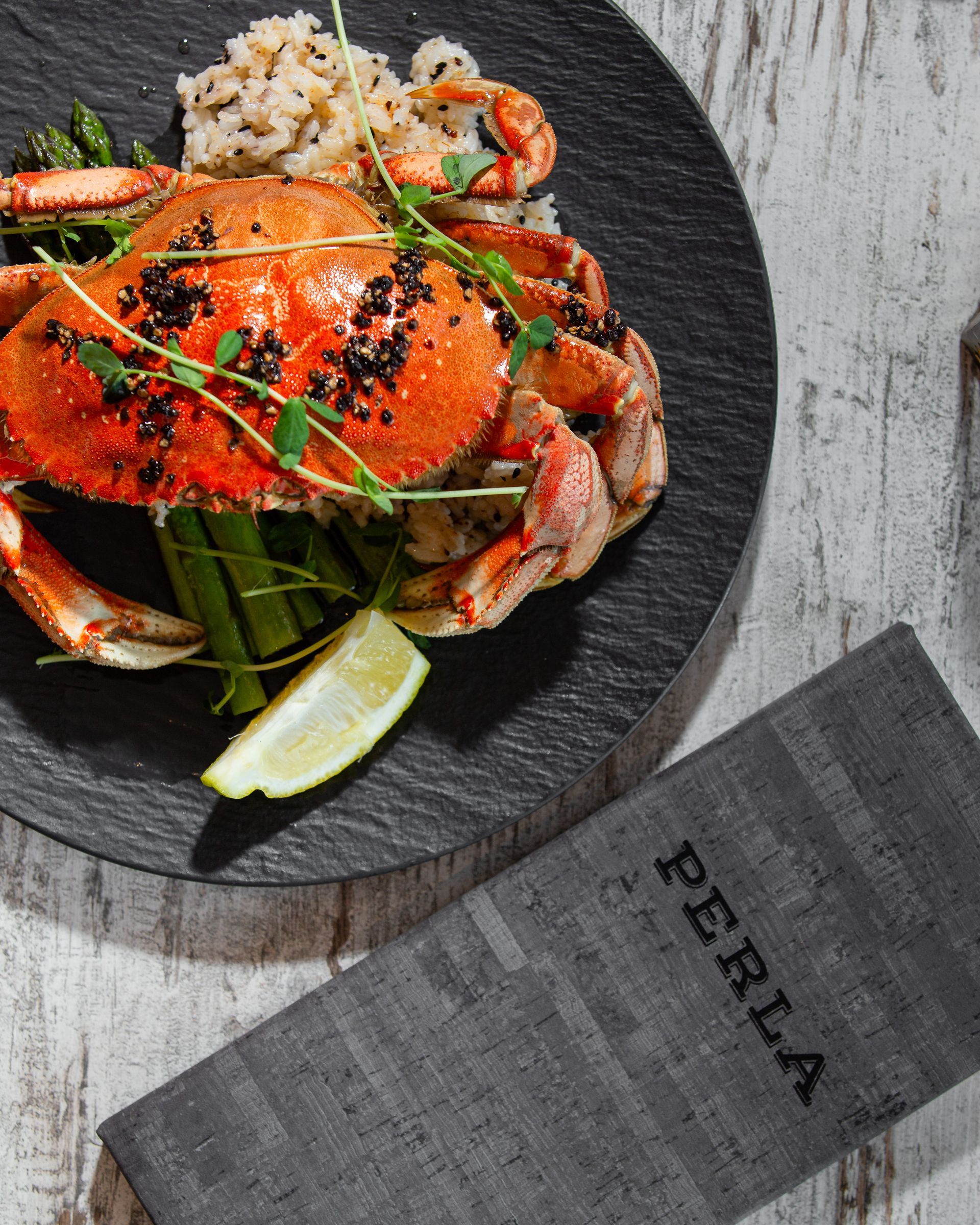 A plate of food with a napkin that says perla on it