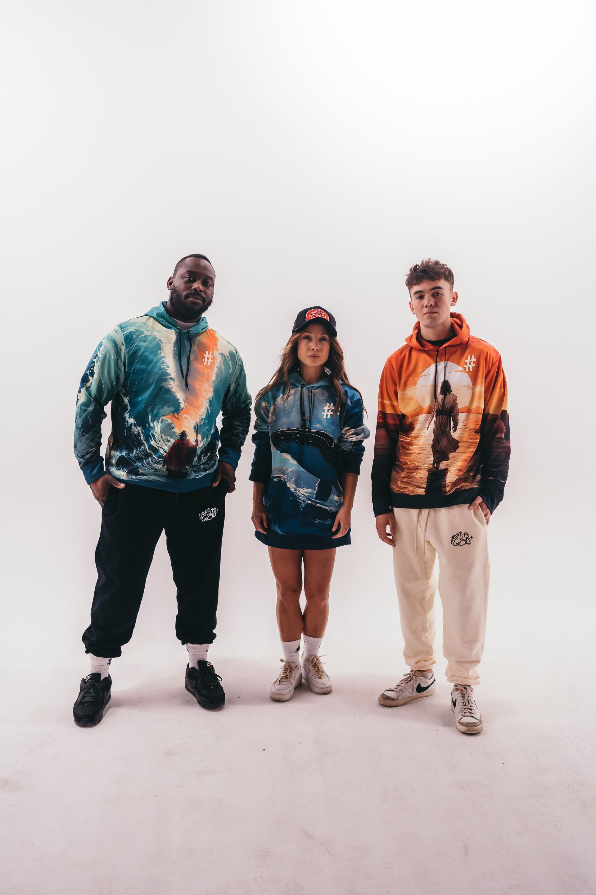 Three people are standing next to each other on a white background.