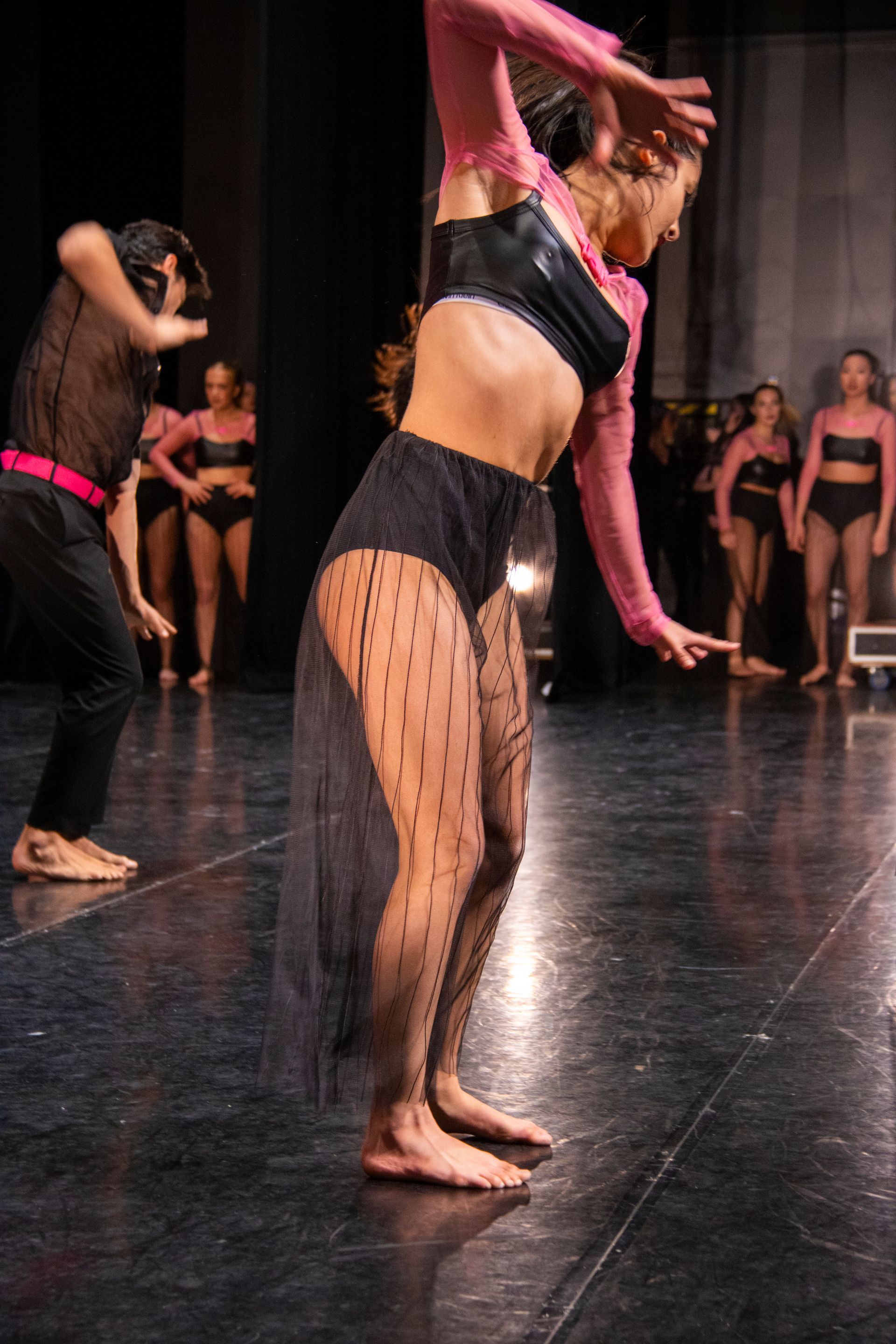 A group of dancers are performing on a stage.