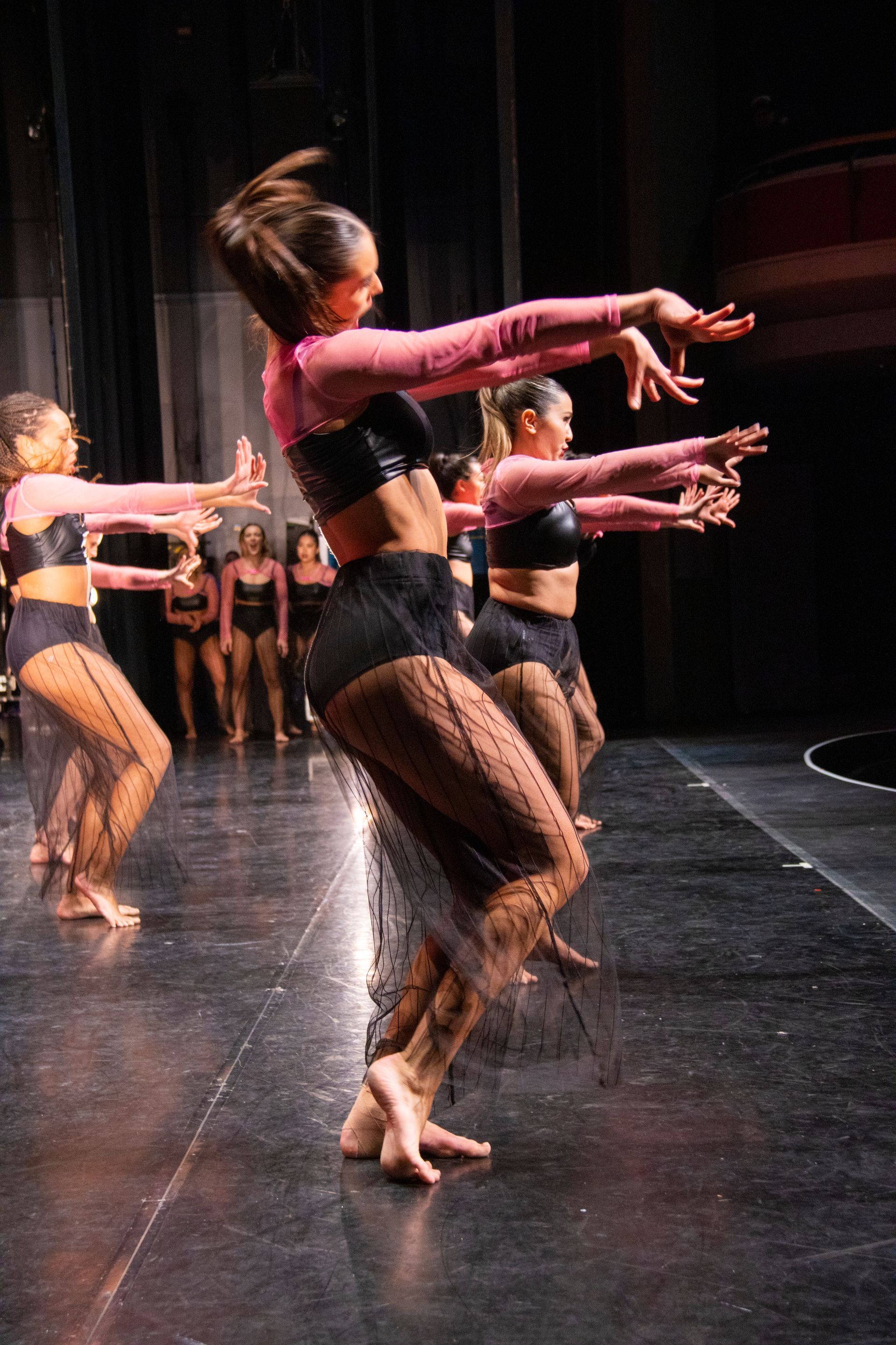 A group of young women are dancing on a stage.