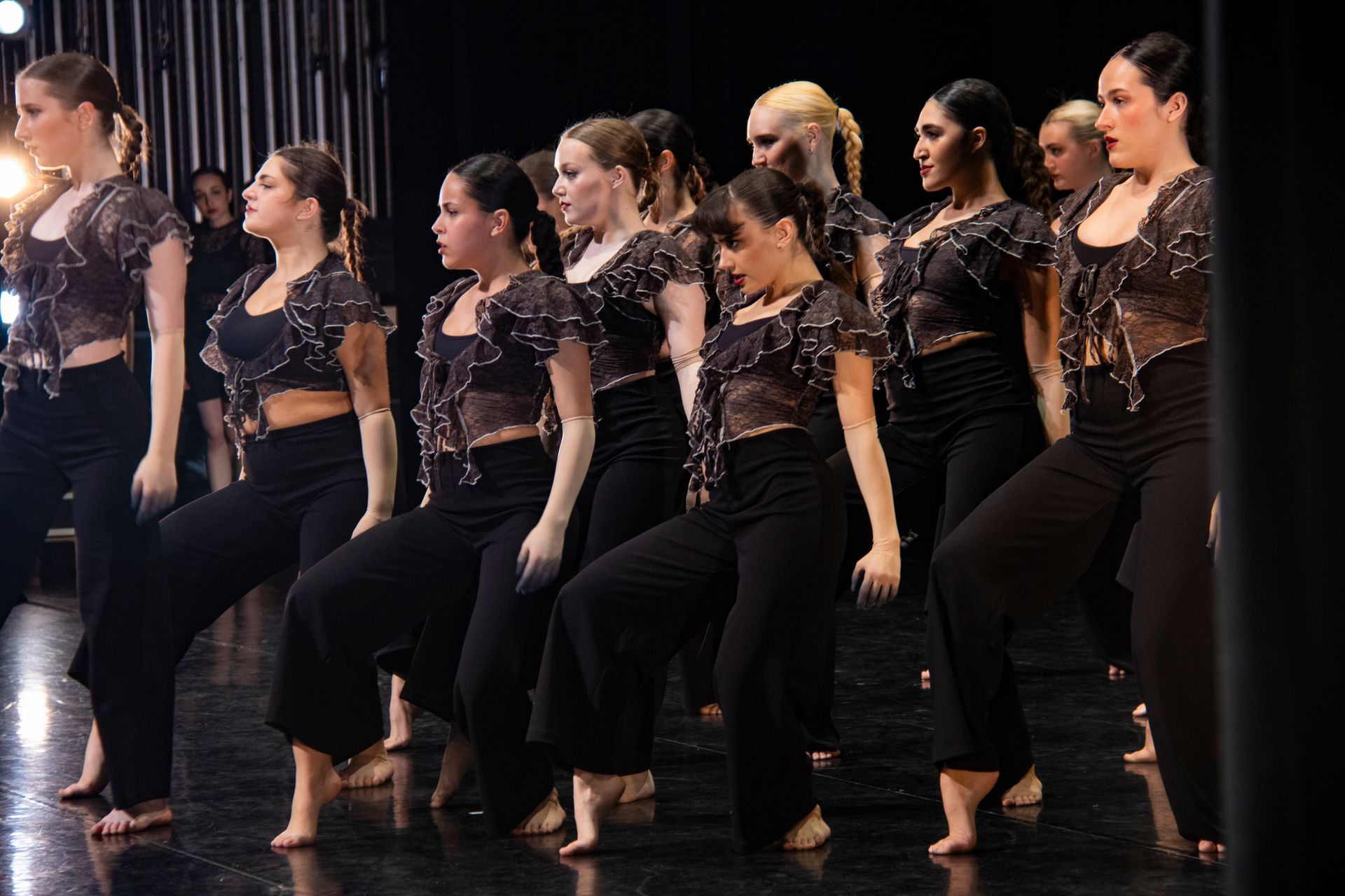 A group of young women are dancing on a stage.