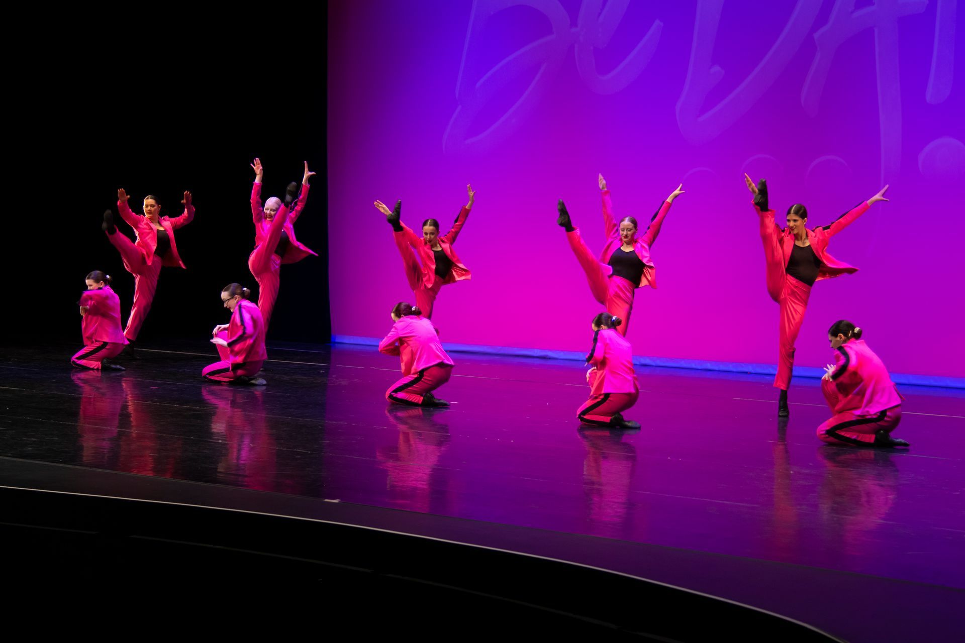 A group of dancers are performing on a stage.
