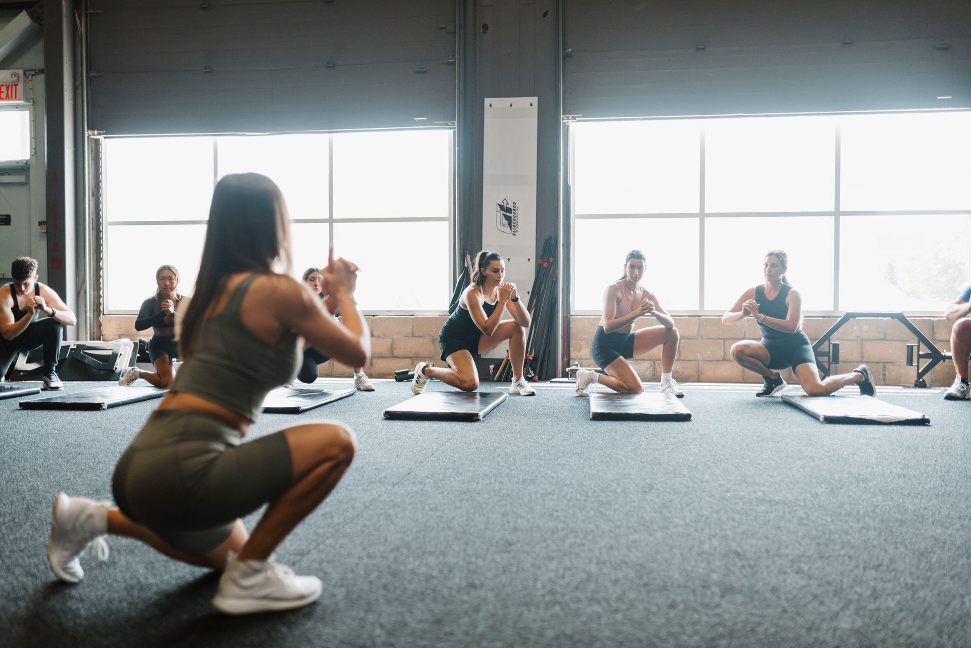 A group of people are doing exercises in a gym.