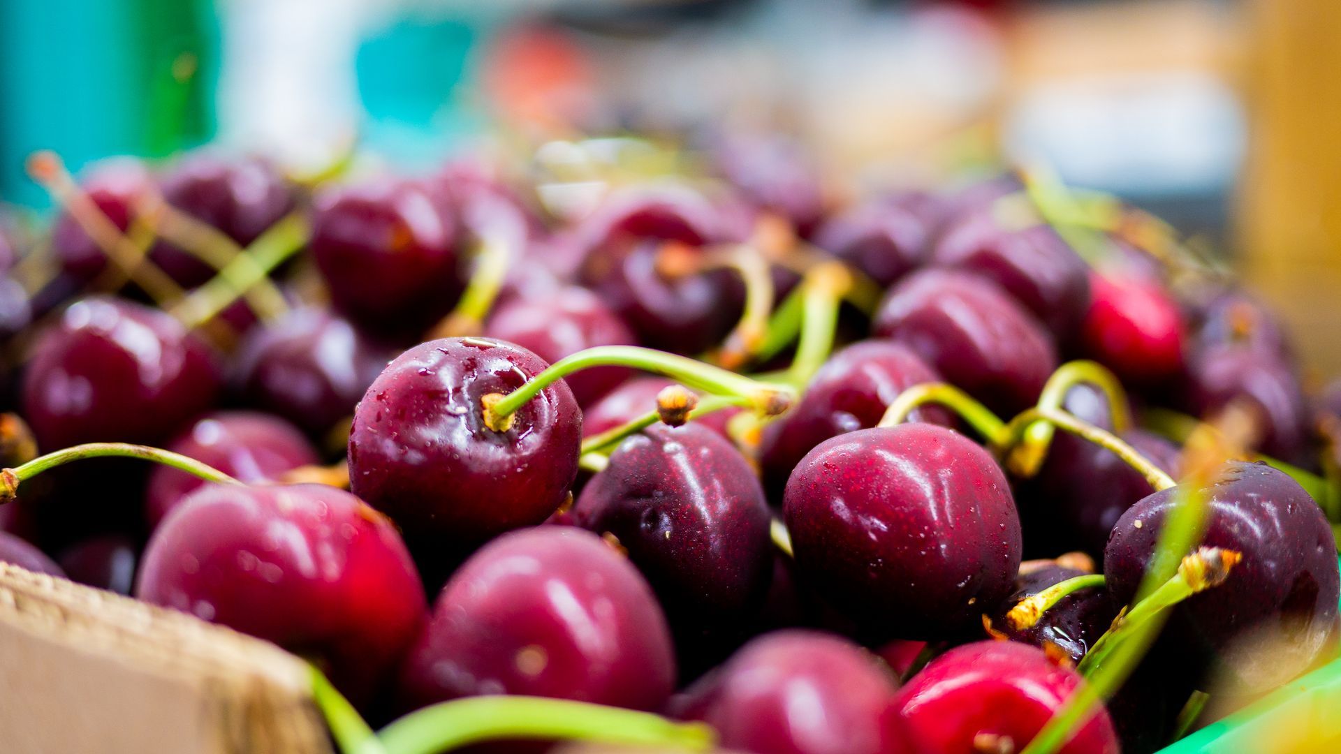 A close up of a bunch of cherries in a basket.