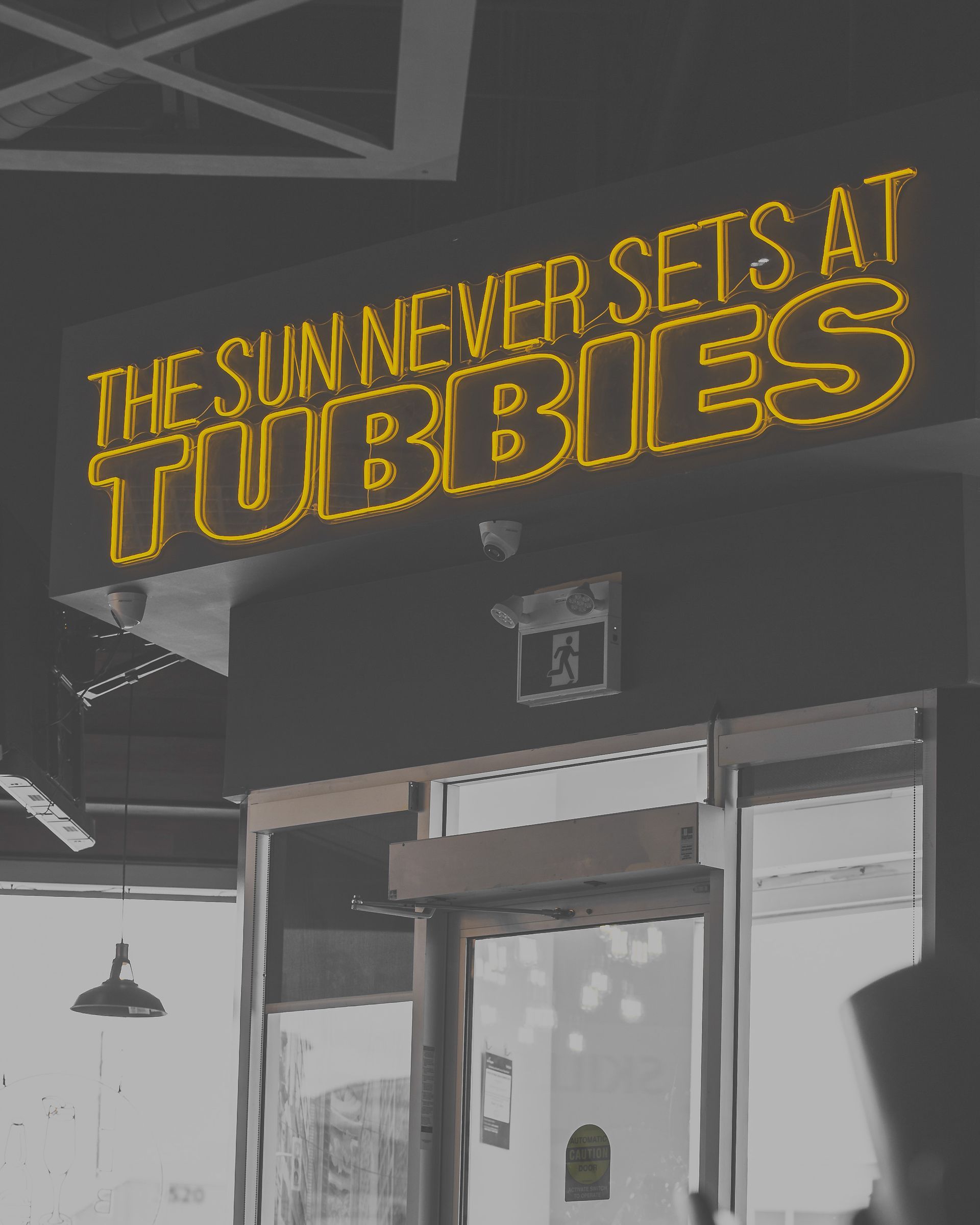 A sign that says the sun never sets at tubbies