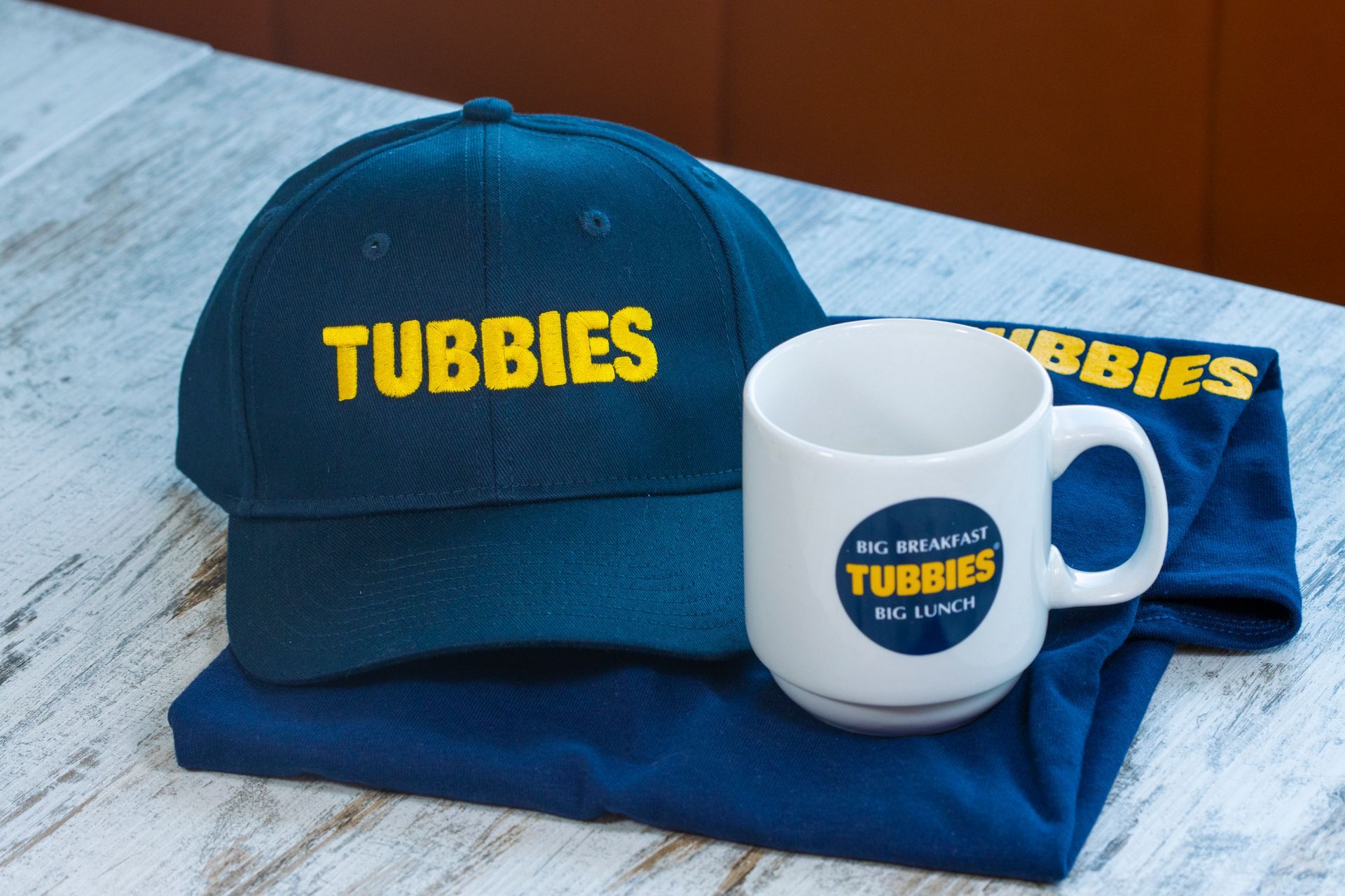 A blue hat with the word tubbies on it