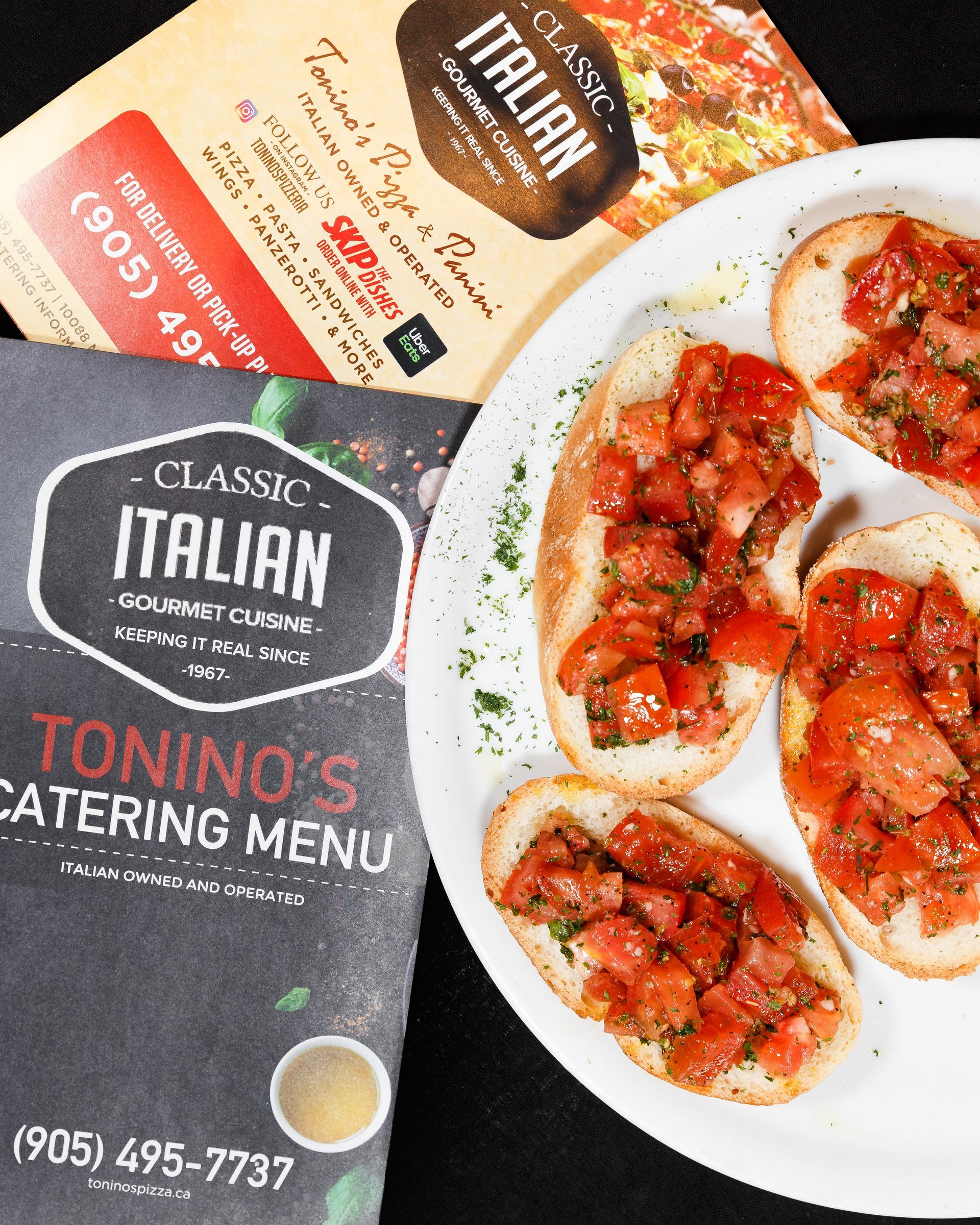 A tonino 's catering menu next to a plate of food