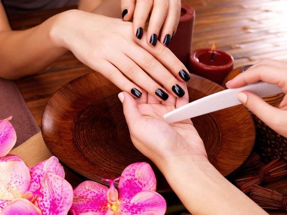 woman getting her nails shaped