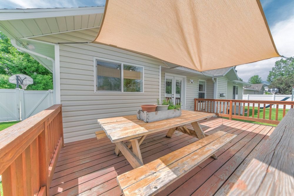 A Wooden Deck With A Picnic Table And Benches — Glenn Merrick Constructions In Bowen, QLD