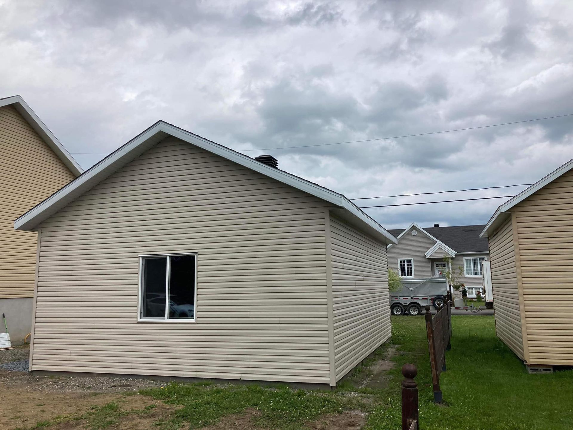 Une rangée de petites maisons sont assises les unes à côté des autres par une journée nuageuse.
