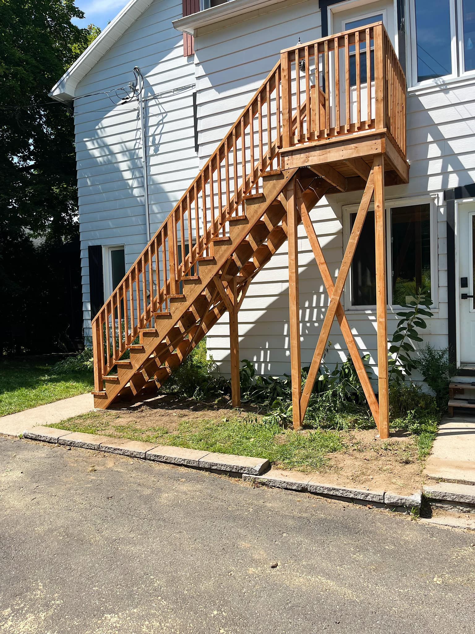 Un escalier en bois mène au deuxième étage d'une maison.