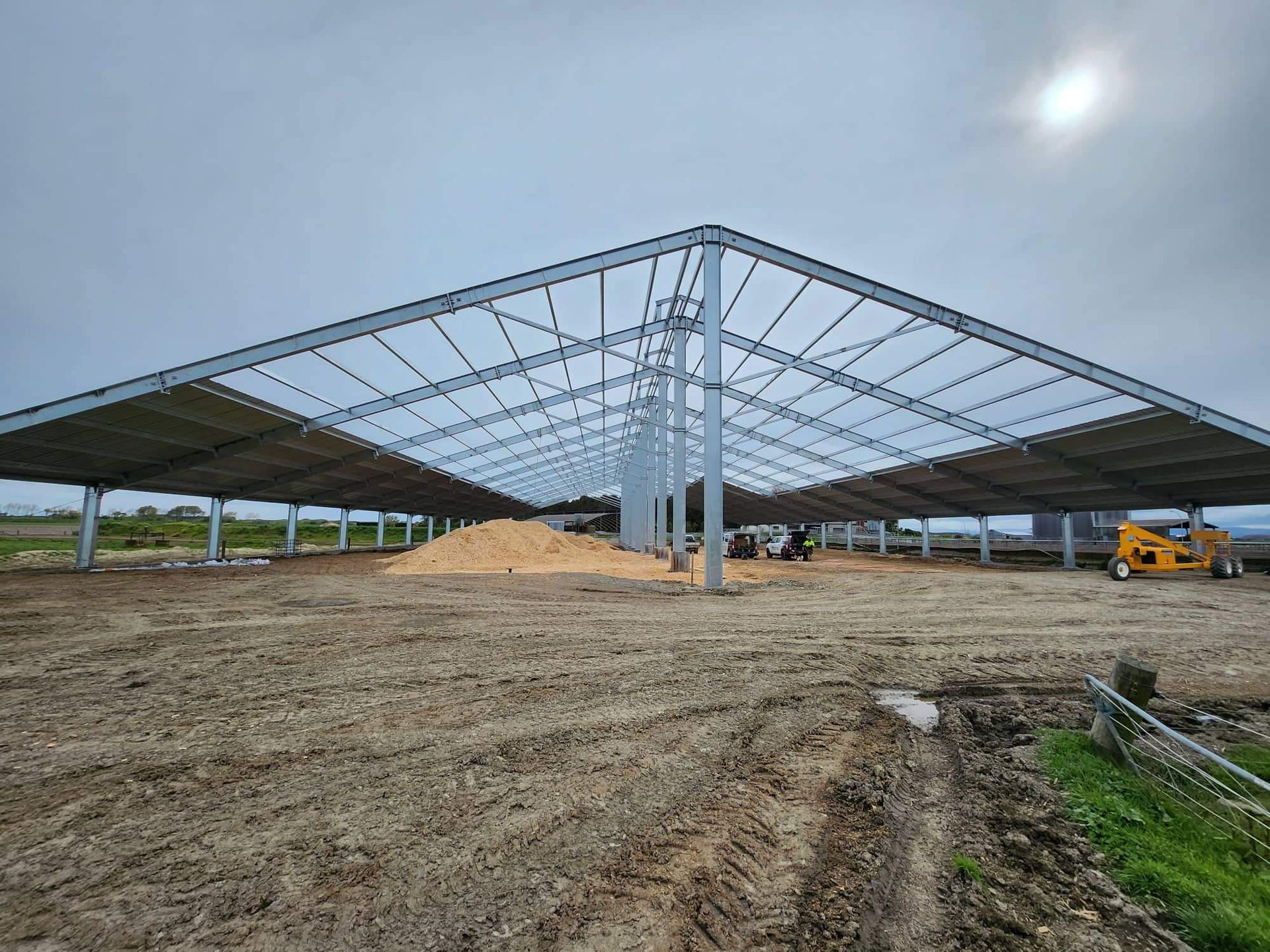 A black house with a wooden deck and stairs