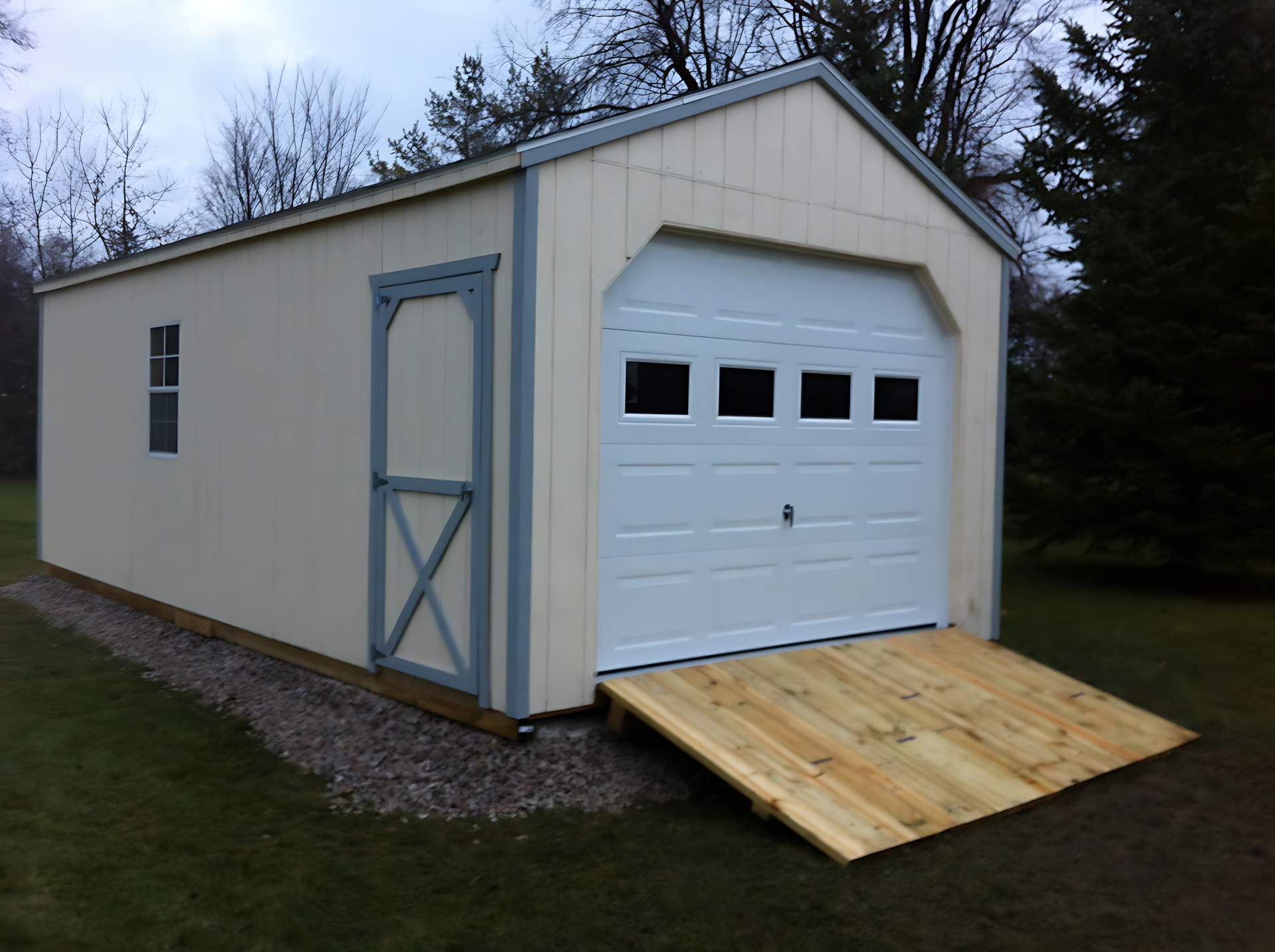 A white garage with a ramp attached to it