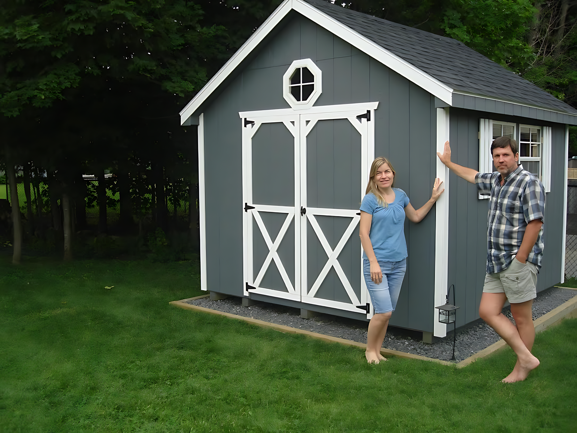 A man and a woman are standing in front of a shed