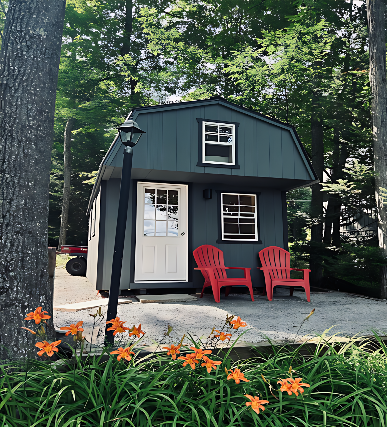 A small house with two red chairs in front of it