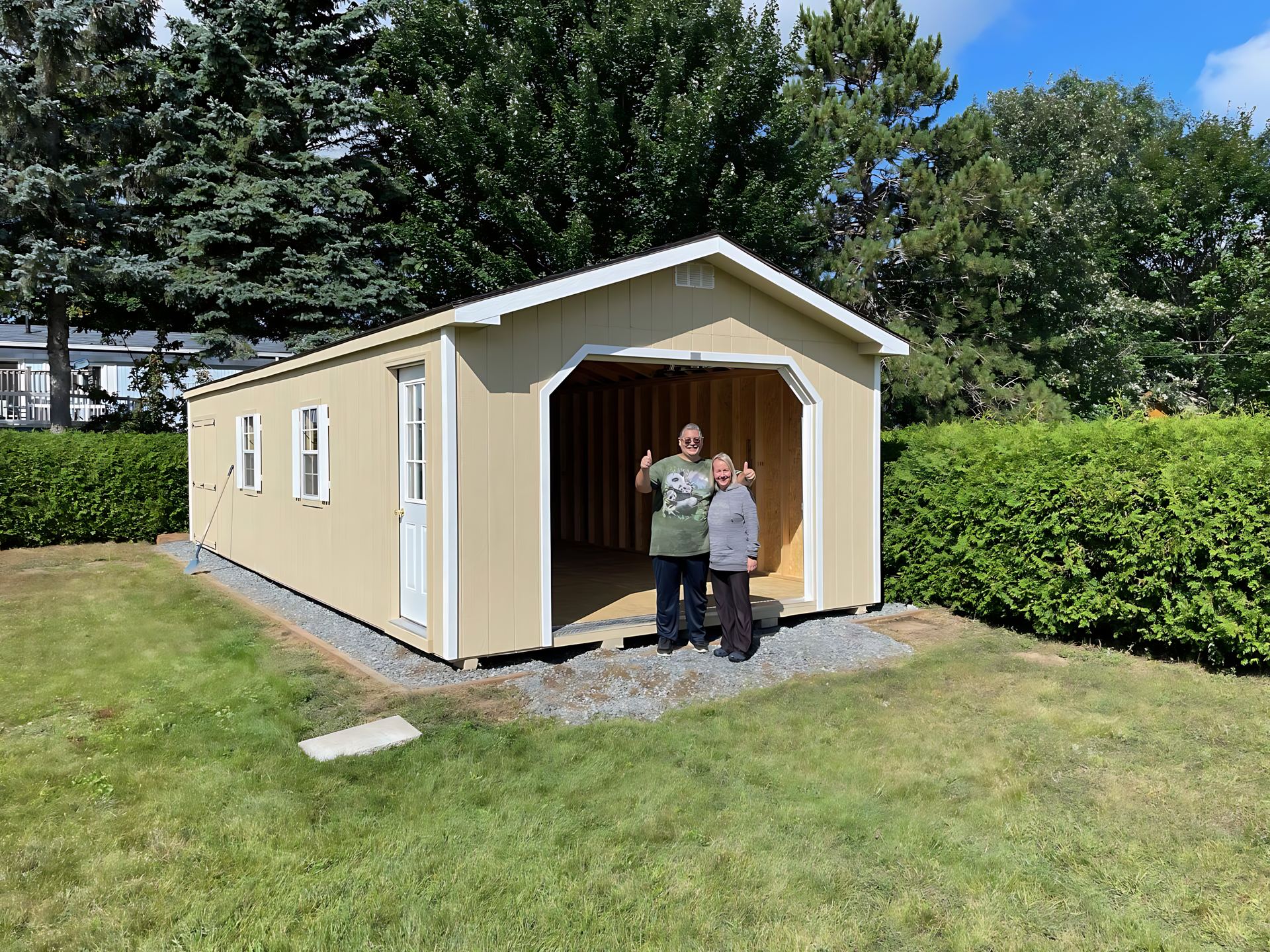 Two people are standing in front of a garage.