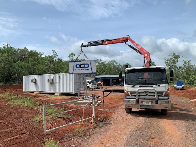 A truck is lifting a large sign with a crane — CCD Electrical In Berrimah, NT