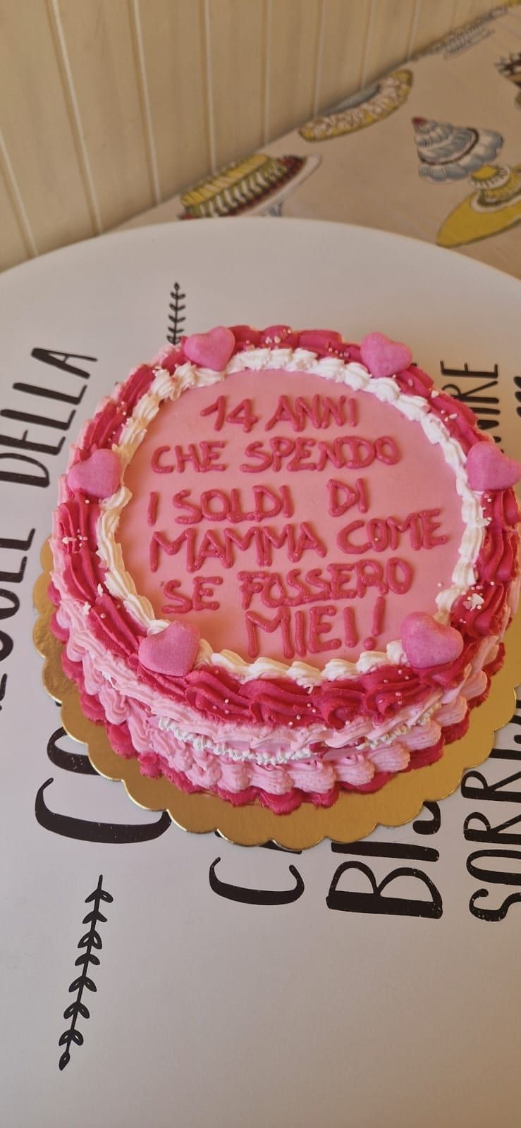 A pink and white layered cake with the words