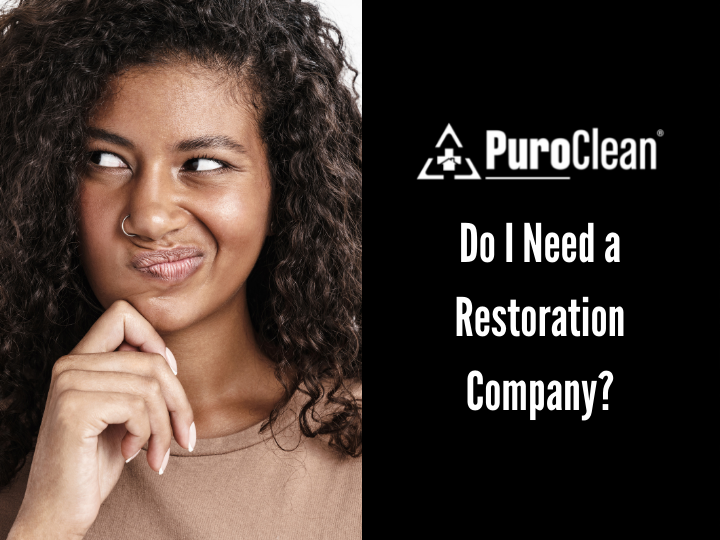 A woman with curly hair is thinking about a restoration company