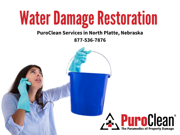 A woman is holding a blue bucket and talking on a cell phone