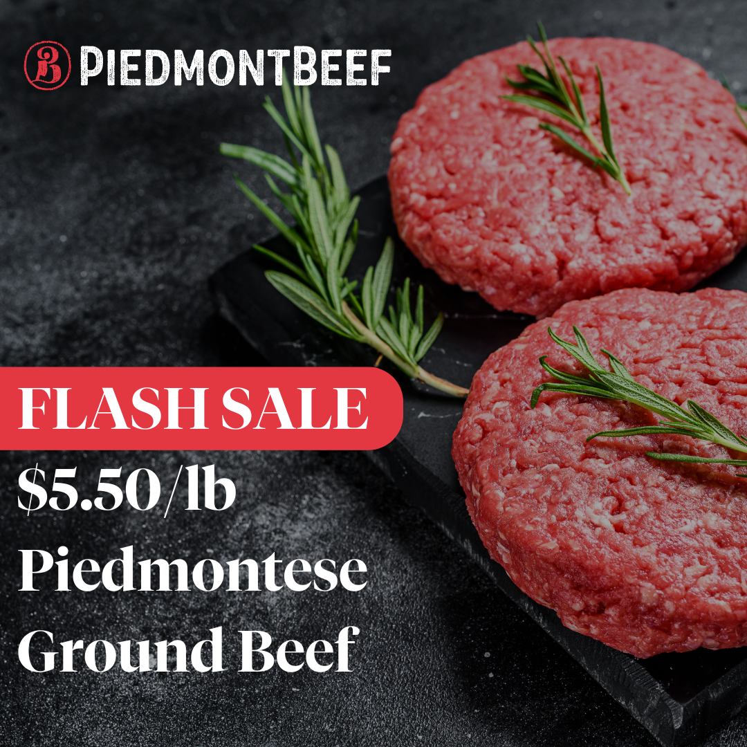 Two ground beef patties with rosemary on a cutting board