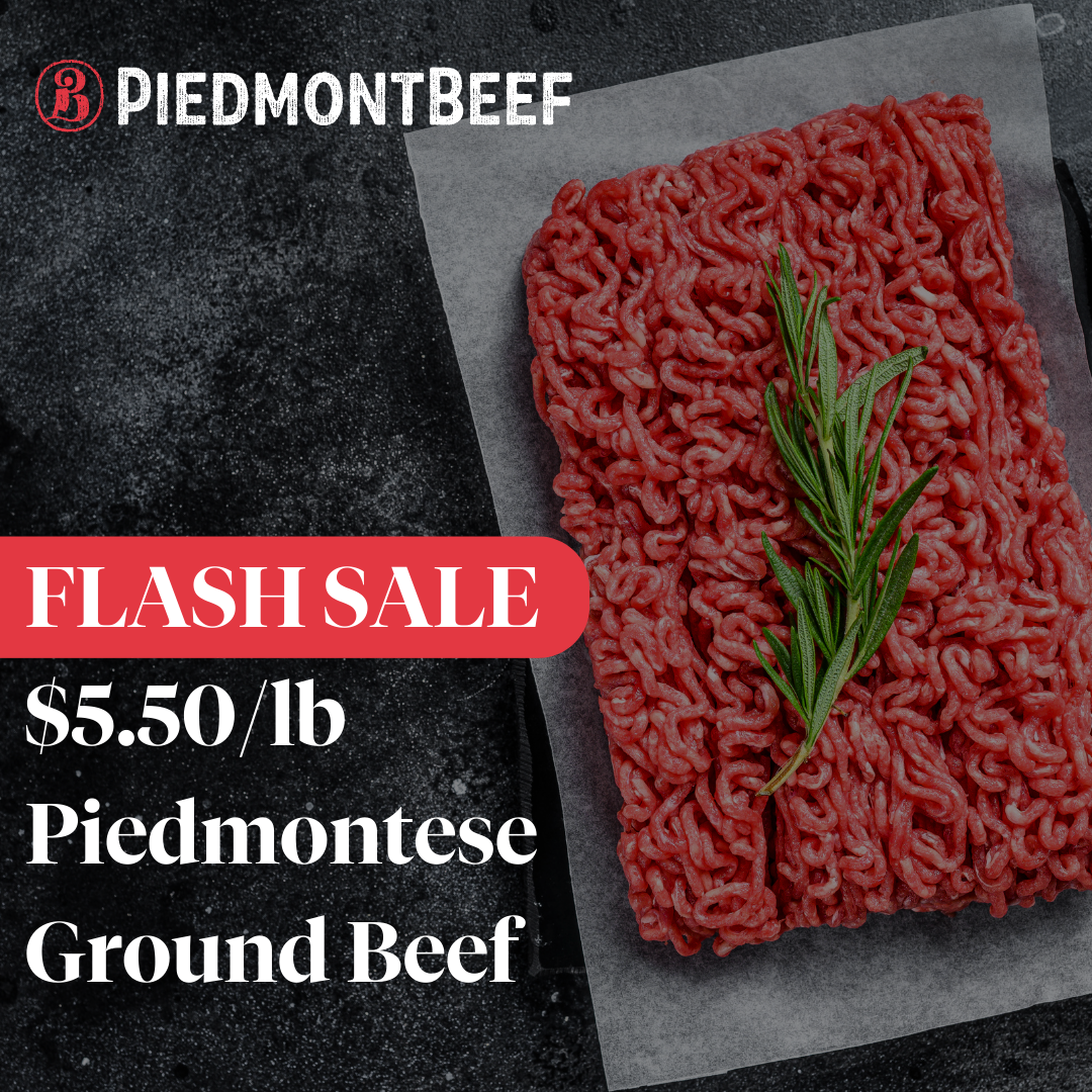 A piece of ground beef with a sprig of rosemary on it