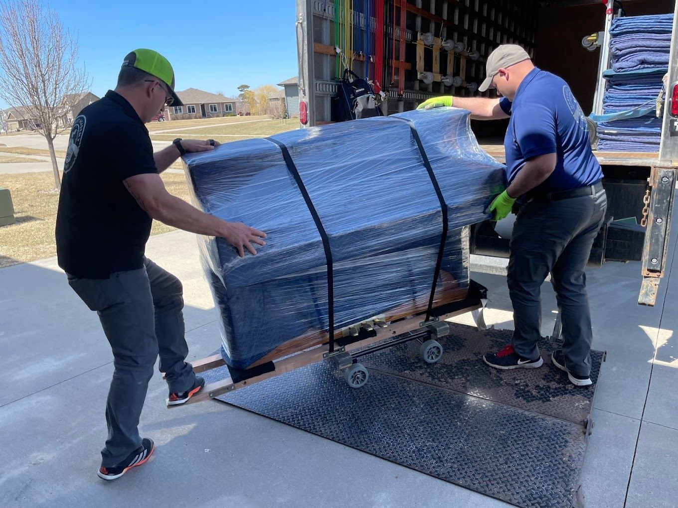 two movers moving a piano safely