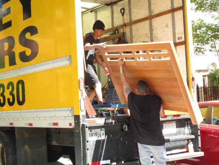 two movers unloading a truck safely
