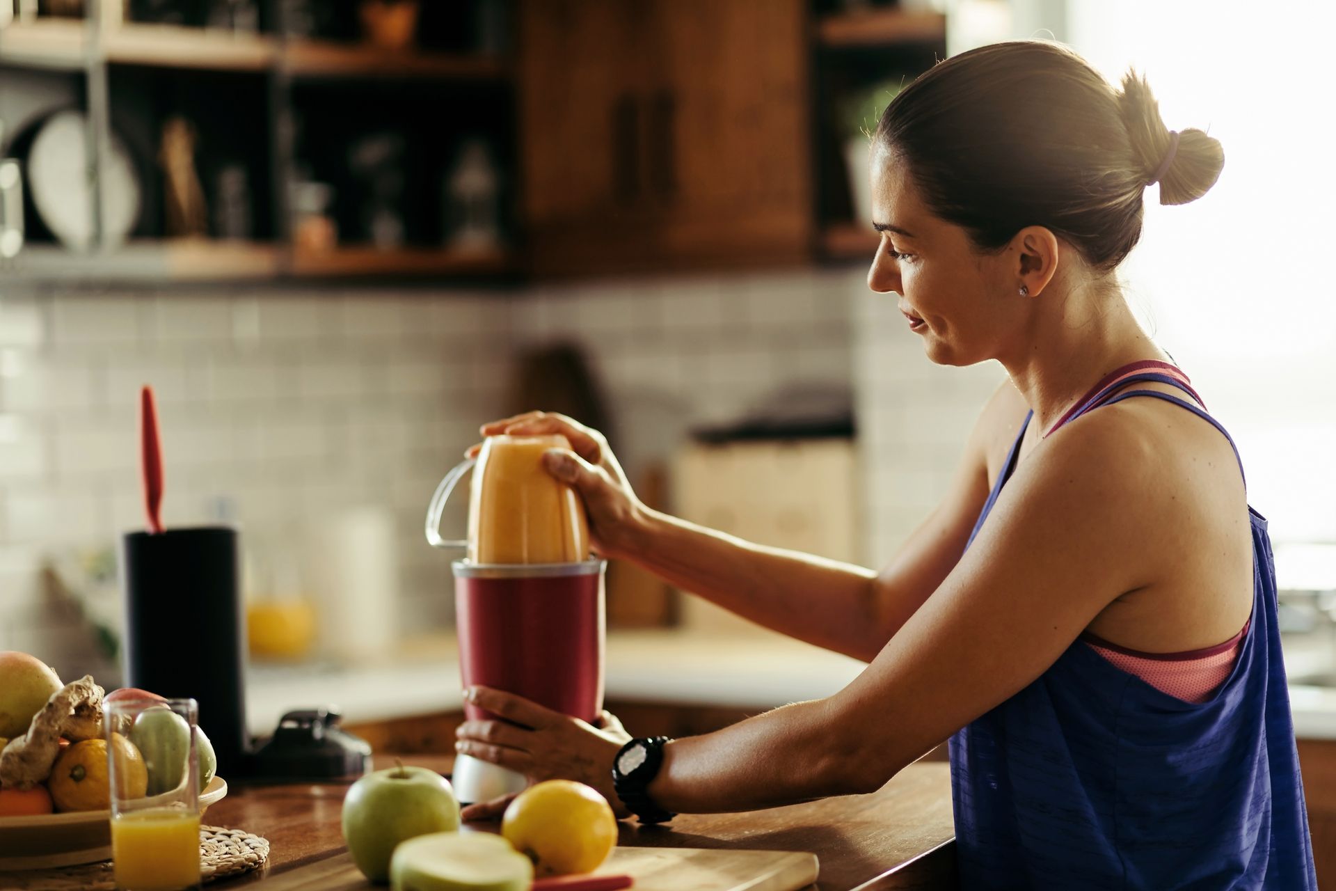 postpartum mom making a smoothie