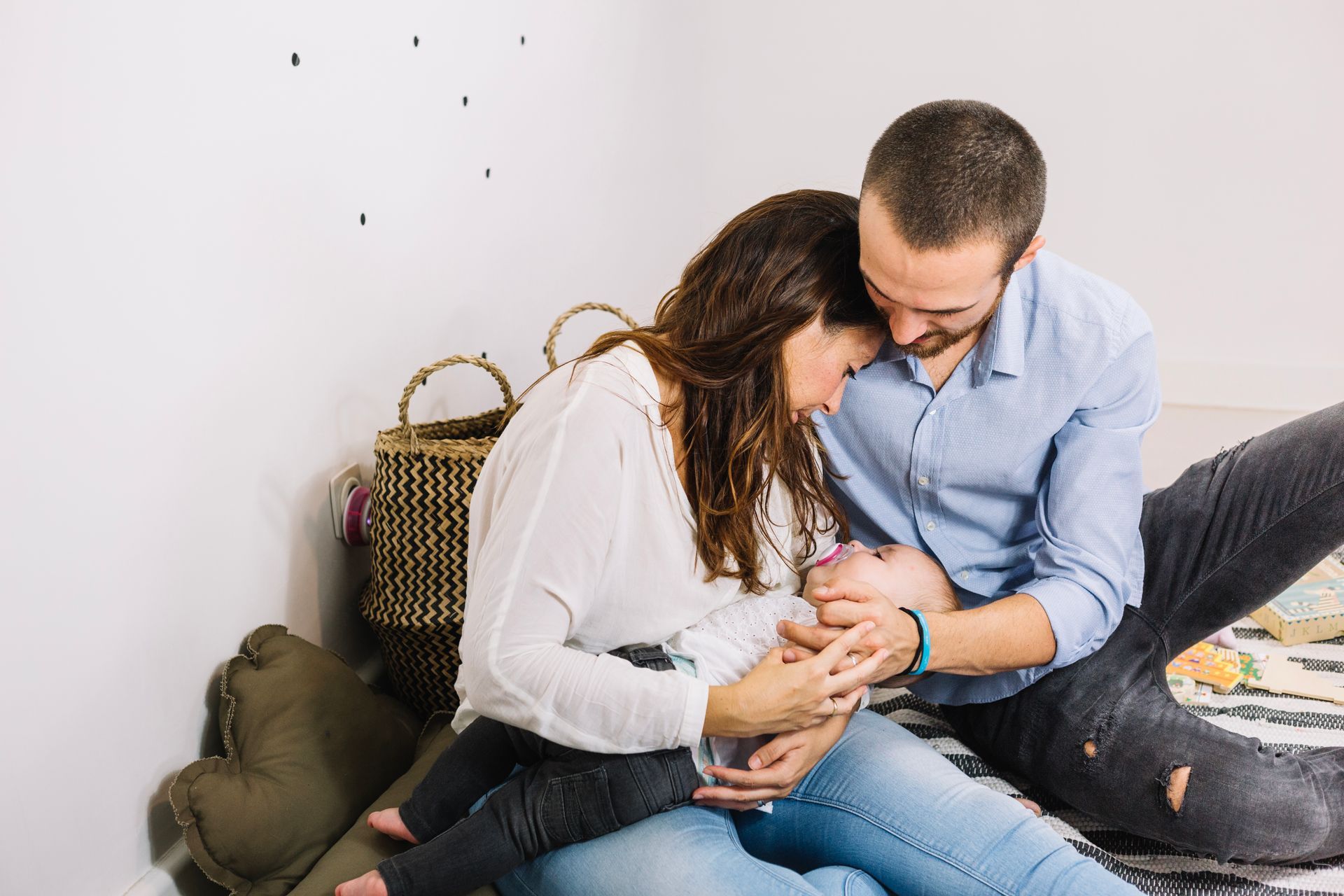 a man and woman holding a newborn baby