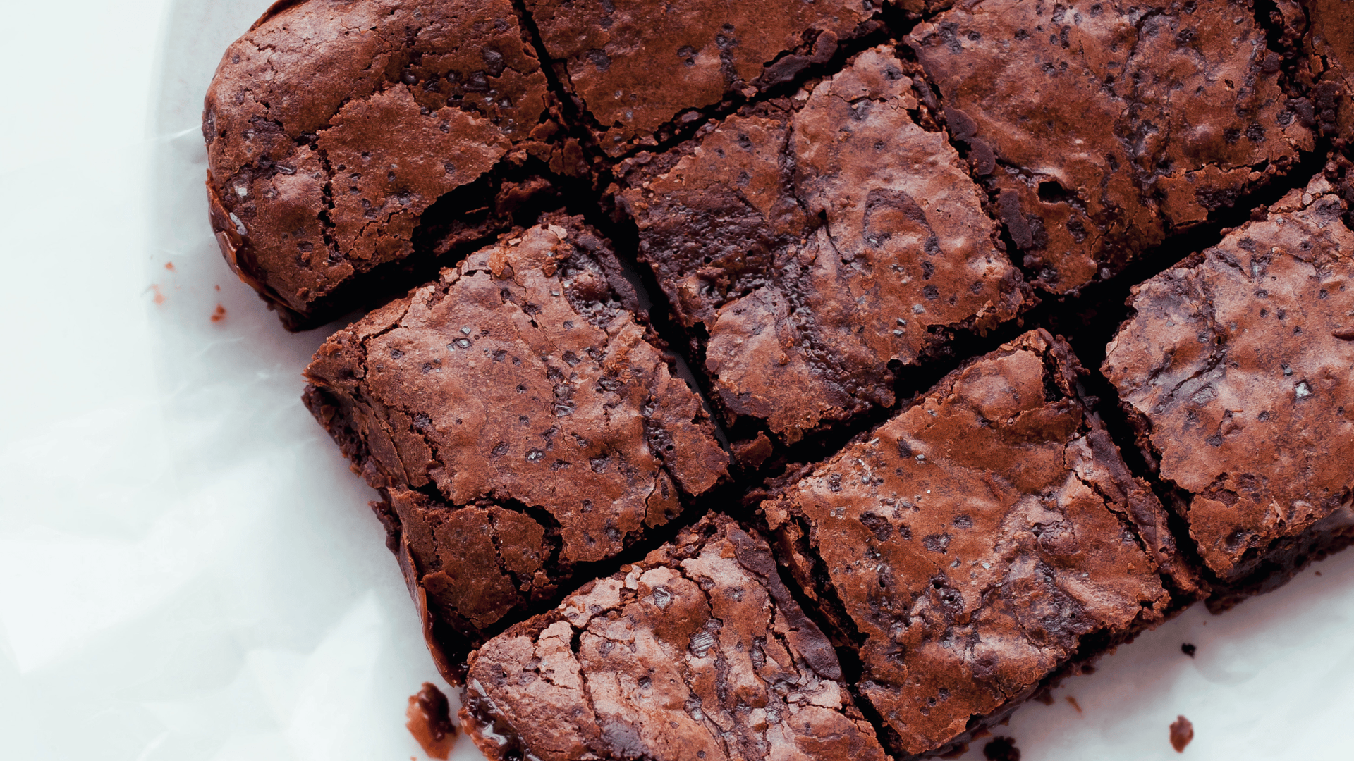 Close-up of freshly baked lactation brownies, sliced into squares.