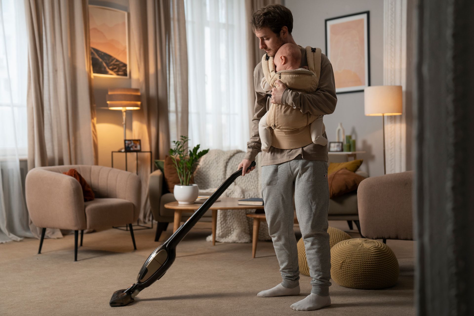 dad using baby carrier to clean